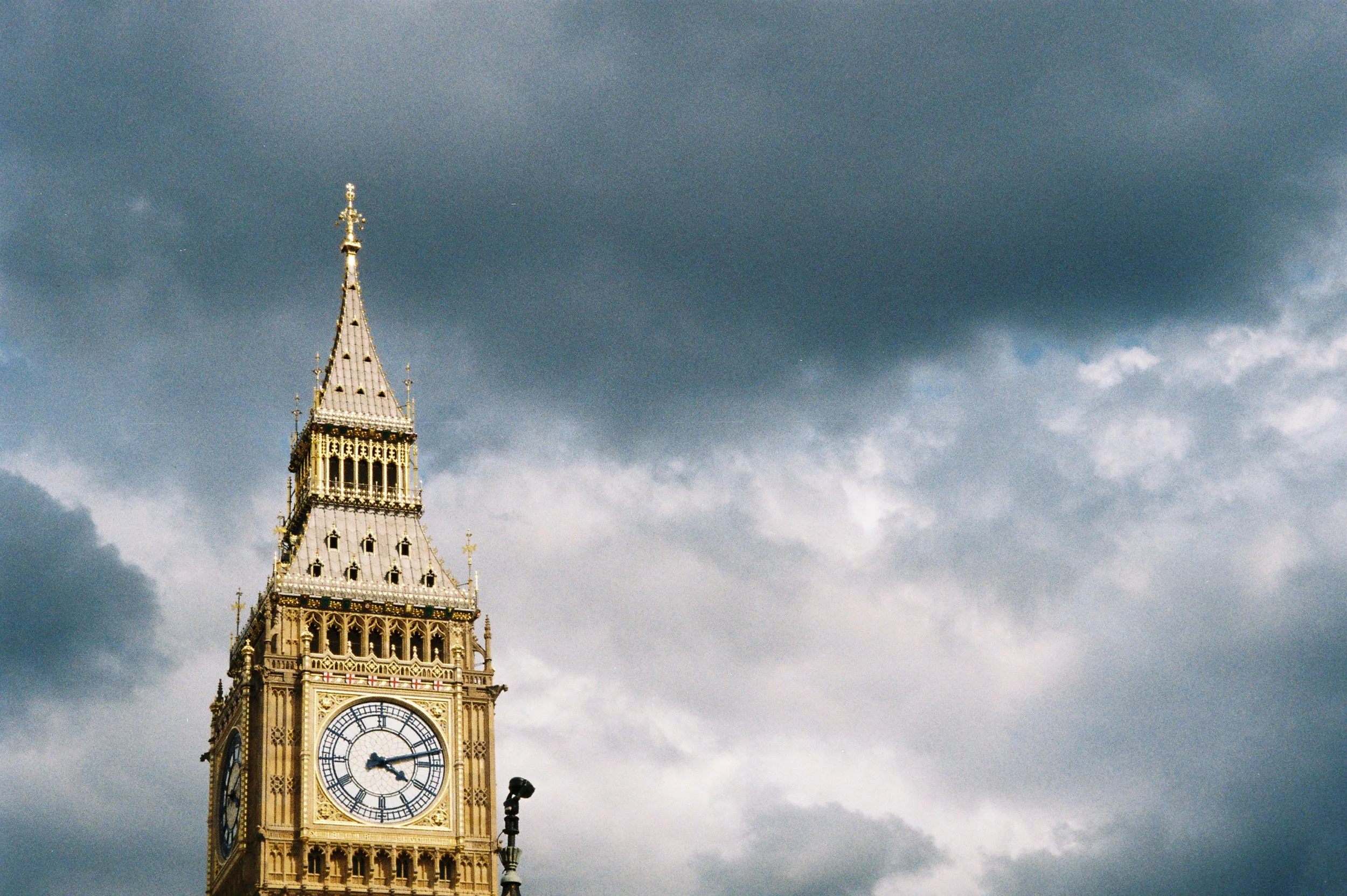 Big Ben clock tower with a dark, cloudy sky in the background.