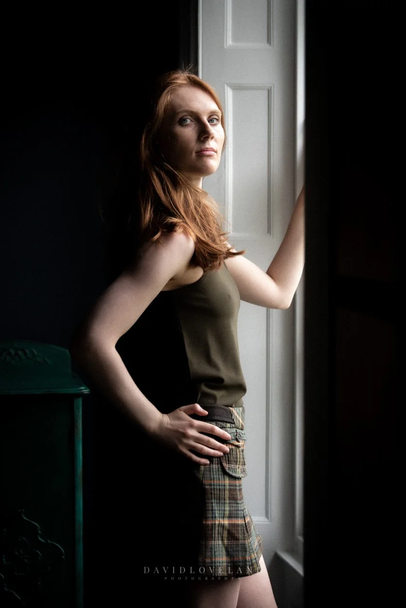 Model Emma Ross wearing Karen Millen tweed check mini skirt. Beautiful red haired, green eyed model in natural light. David Loveland Fashion Photography and Styling  