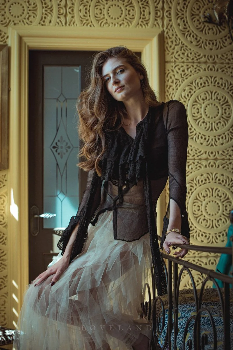 Tall beautiful model with cream tulle skirt, Dolce Gabbana blouse in opulent fashion editorial location shoot in Church Stretton, David Loveland Fashion Photography