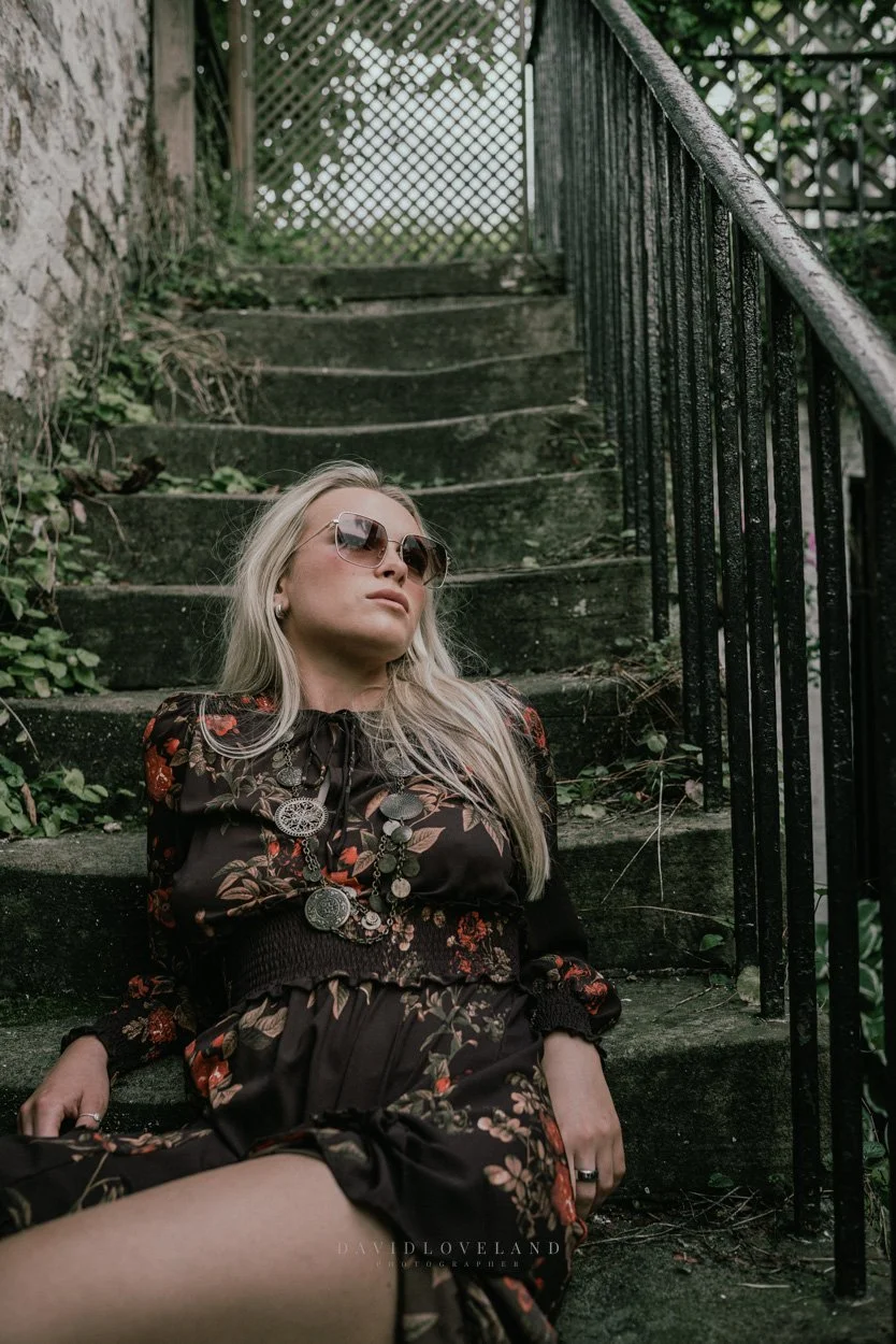 Model Amy Stubbs sitting in a chocolate Zara brown dress. Georgian opulent courtyard in Peak District, David Loveland Fashion Photography  