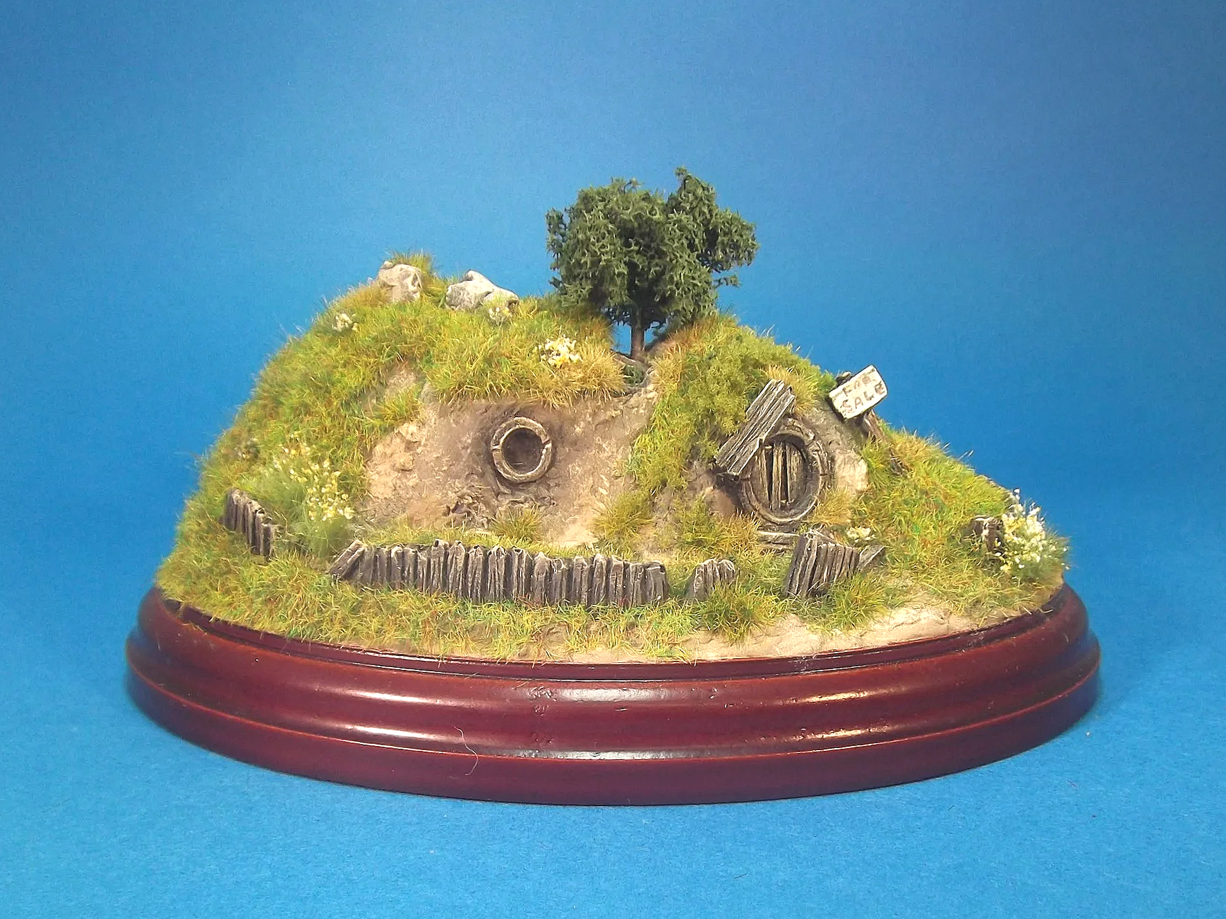 'The pleasant row of old hobbit-holes in the bank on the north side of the Pool were deserted, and their little gardens that used to run down bright to the water's edge were rank with weeds'