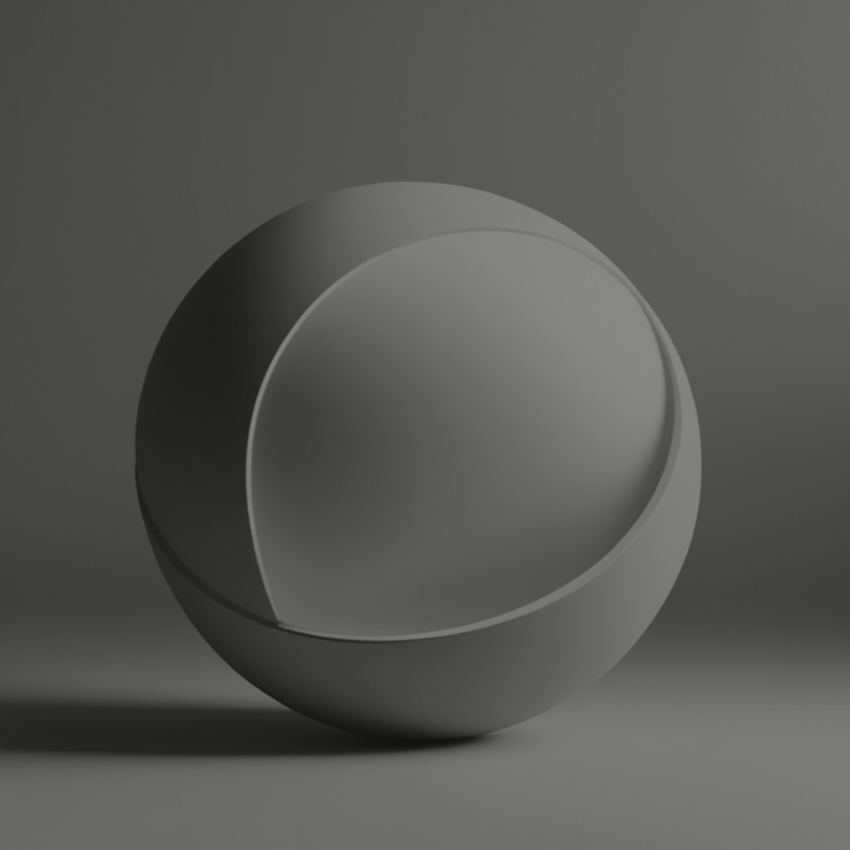 A gray, spherical object with an open section, set against a gray background, creating a shadow on the surface.
