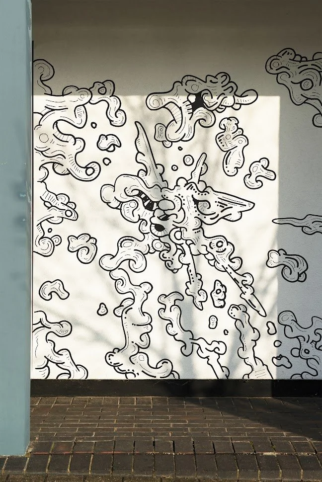 Black and white abstract mural painted on a wall.