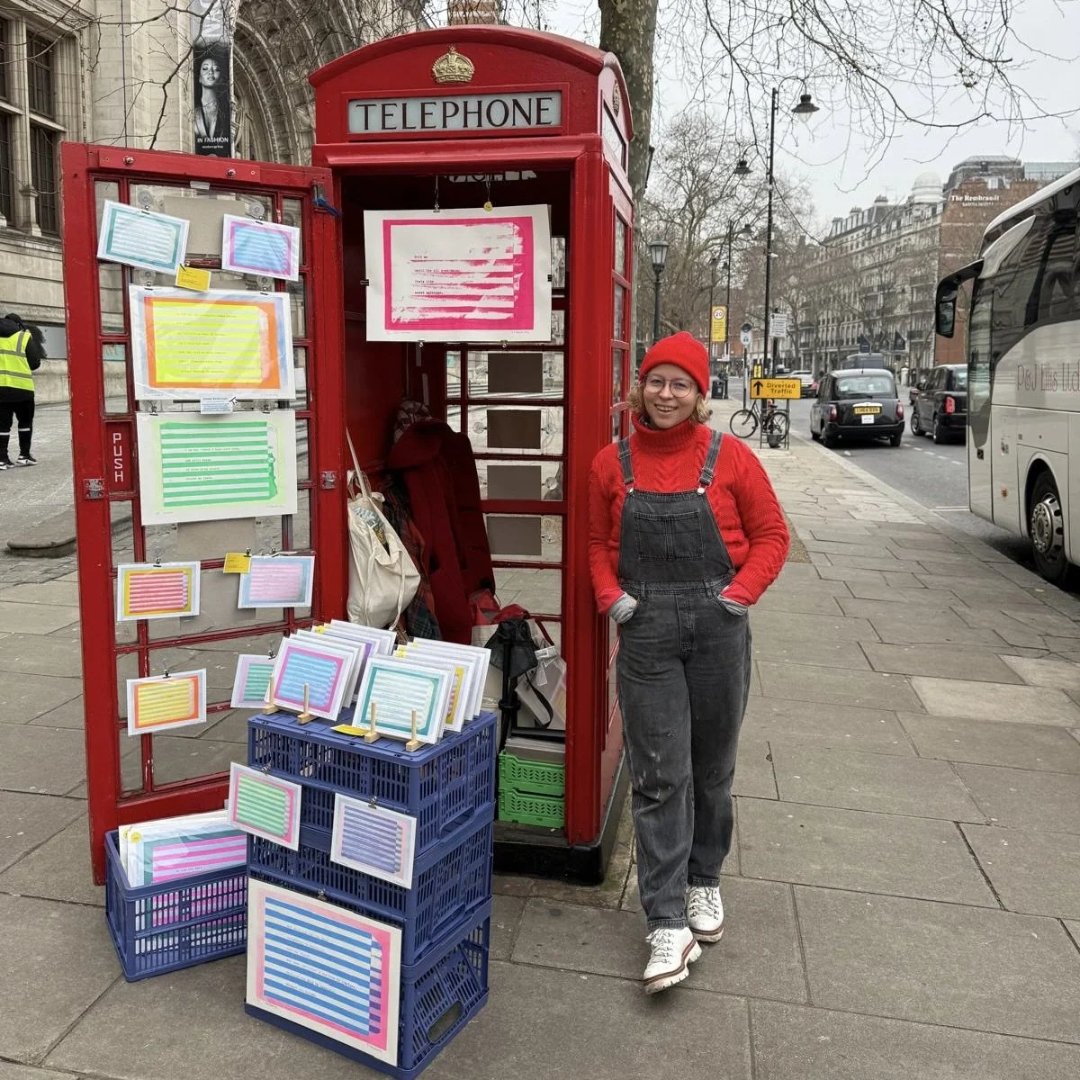Telephone Box in London outside V&A Museum, mini art exhibition displaying colourful risograph prints