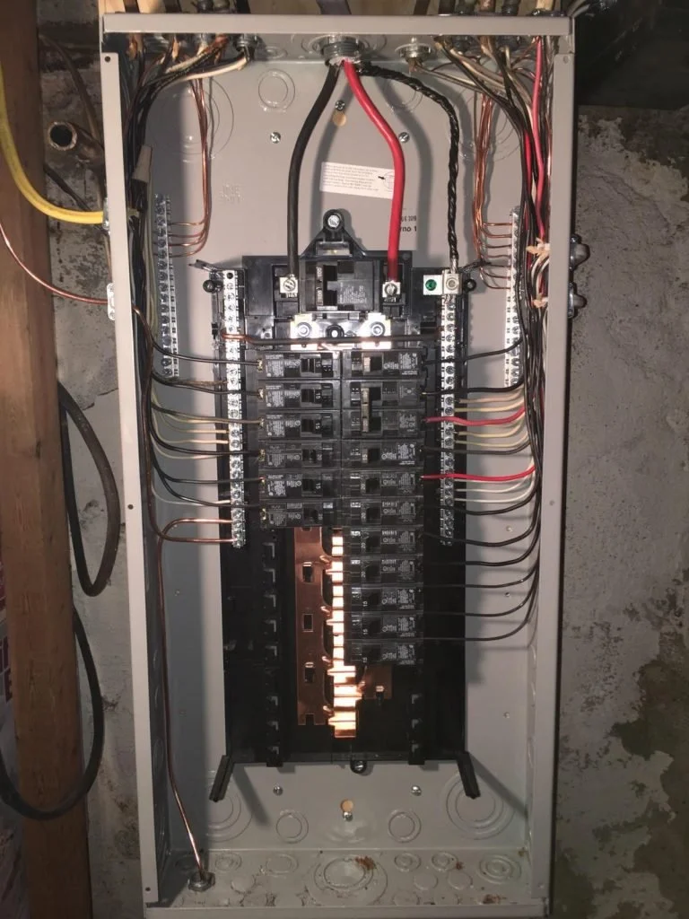 Interior view of an electrical breaker panel with multiple switches and wiring.
