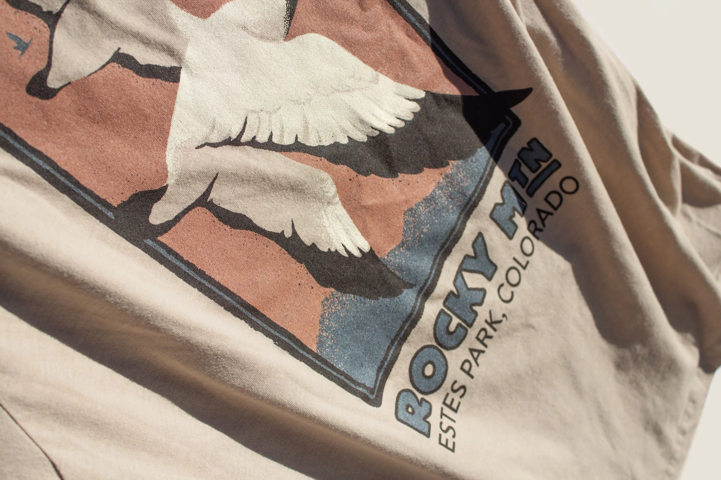 A detail picture showing the soft fabric of the tshirt and the graphic of the geese flying
