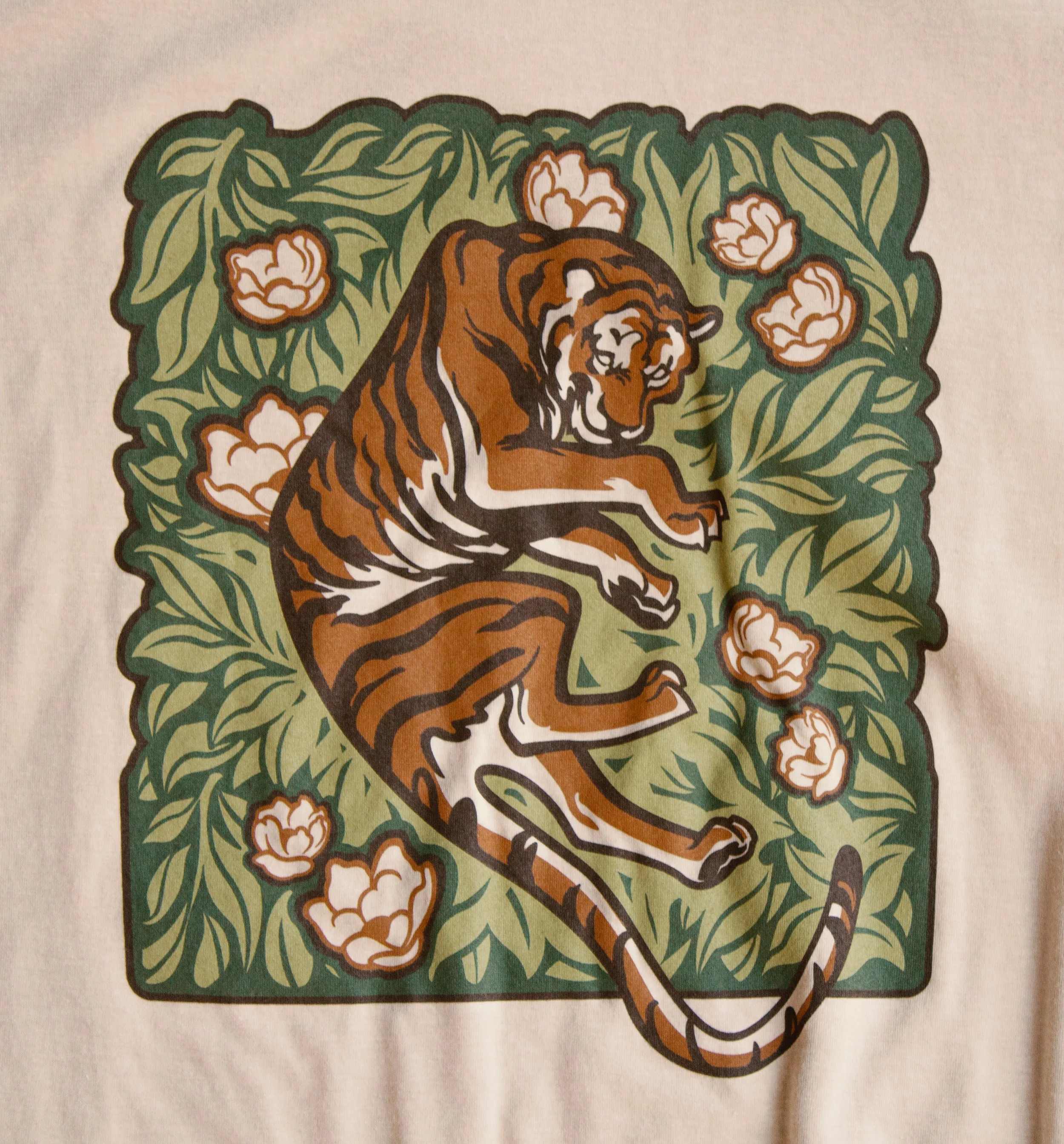 A closeup of the detail of the tiger illustration on the t-shirt