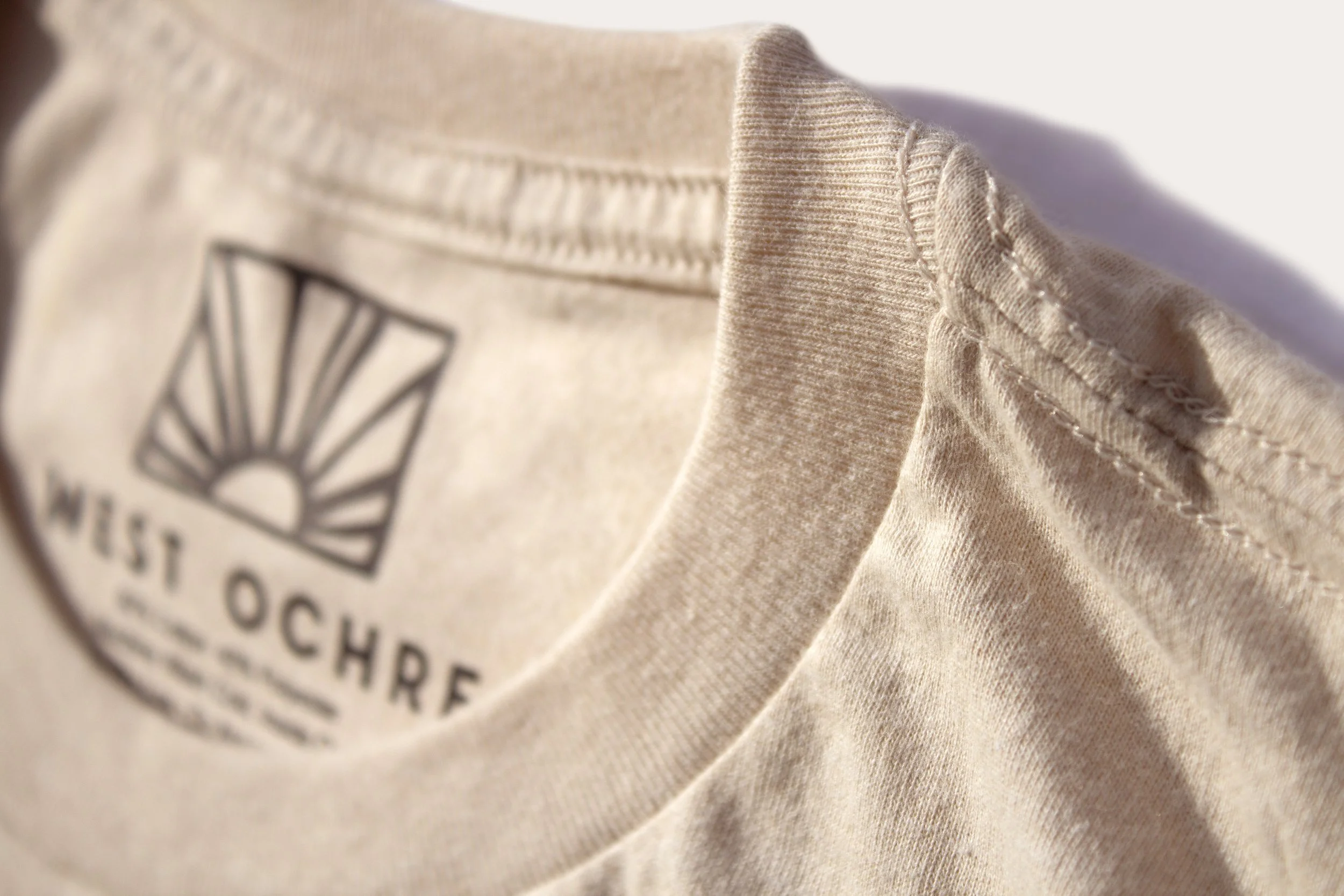 A closeup of the neck and shoulder stitching on a t-shirt
