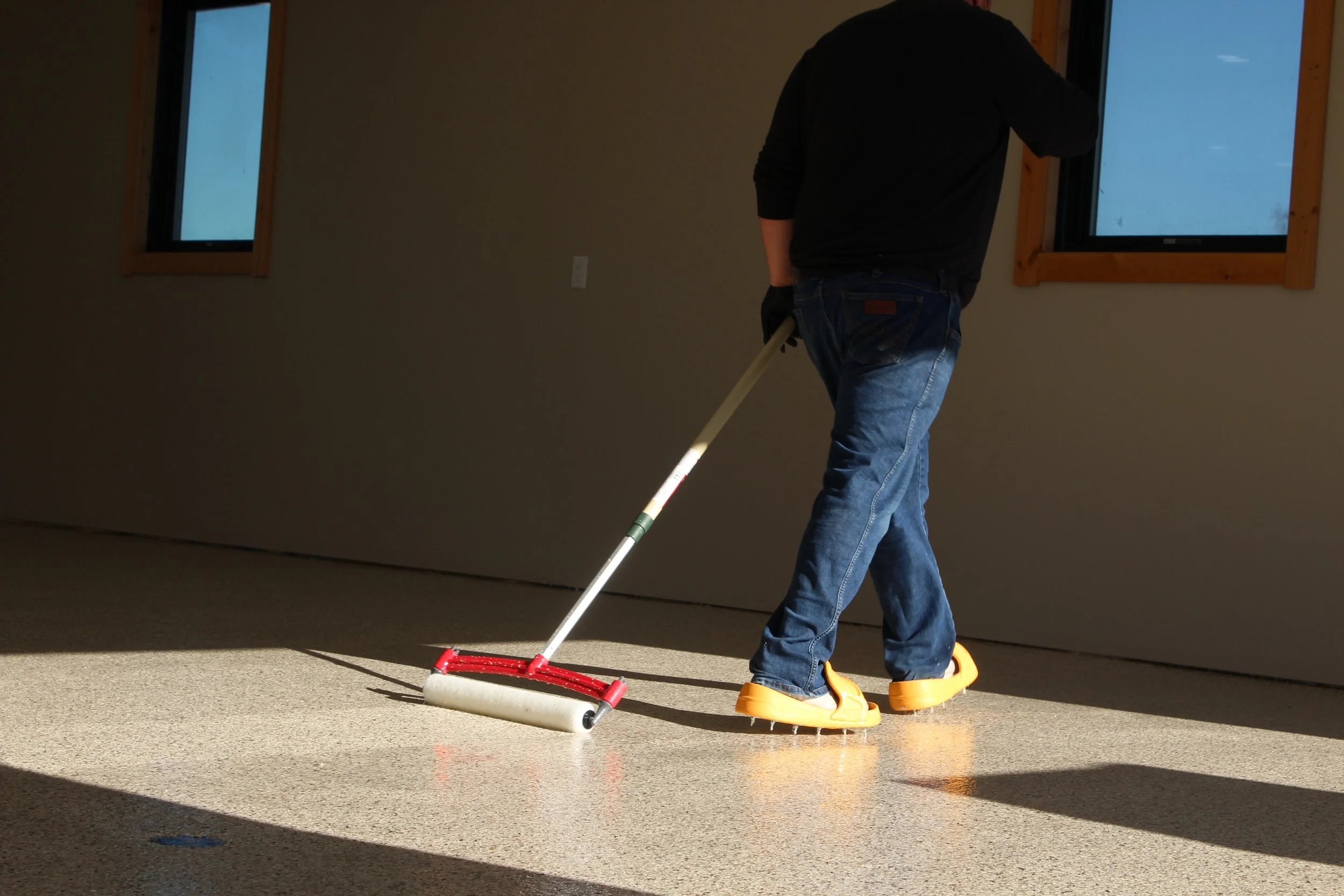 Interior surface preparation in progress for a concrete floor coating system, showing professional prep work that ensures proper adhesion of epoxy and polyaspartic flooring.