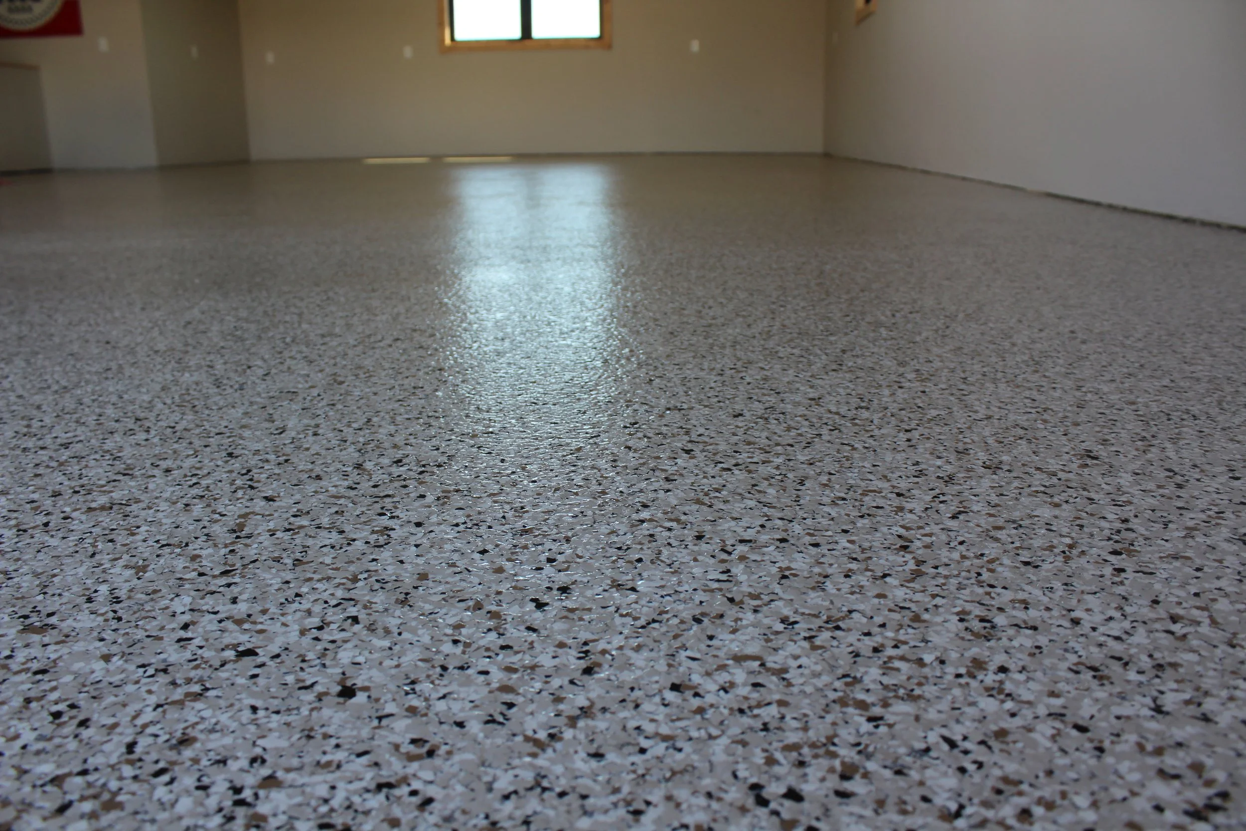 Decorative flake epoxy floor system installed by ProTek Surface Systems in Iowa City Iowa