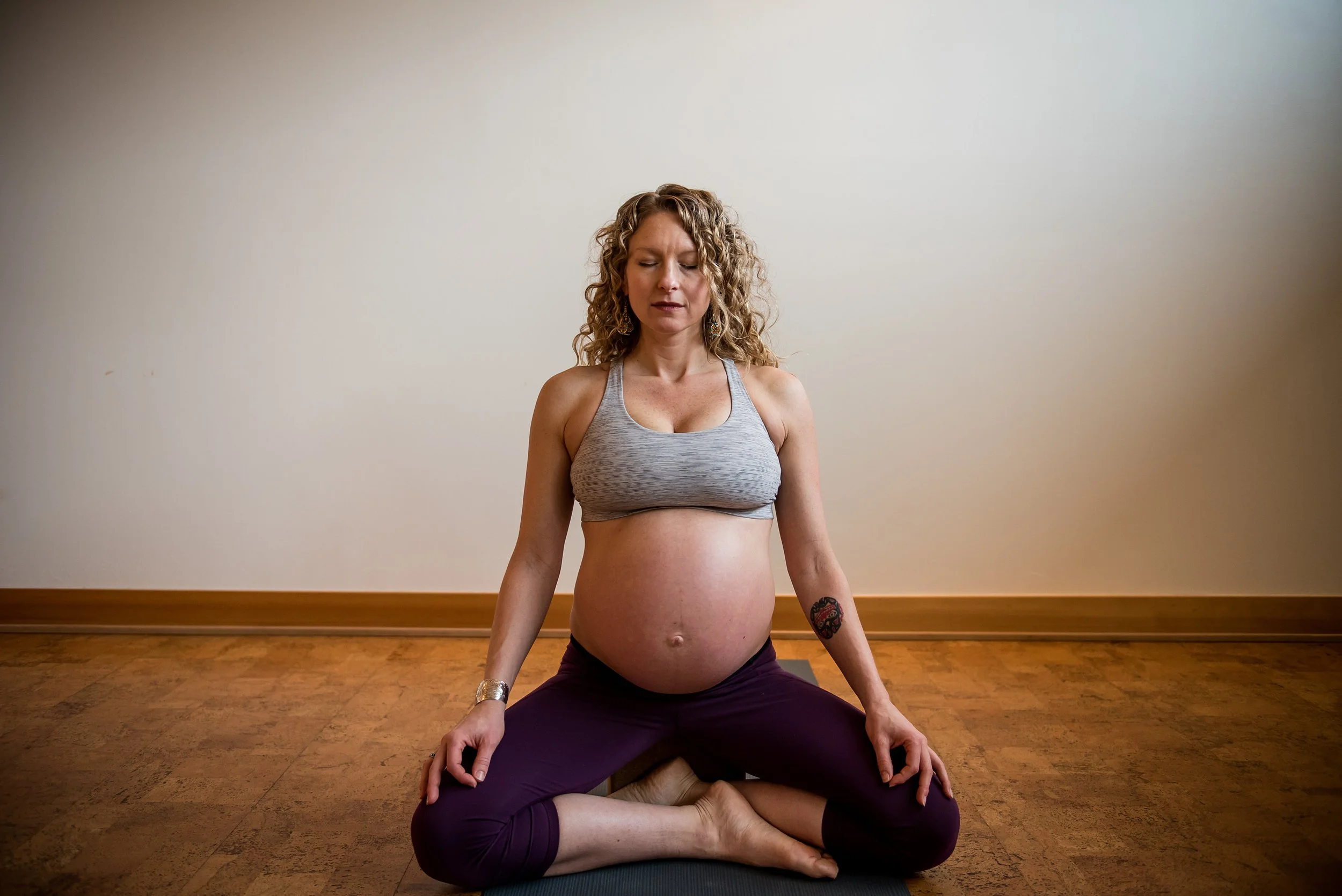 Woman practicing prenatal yoga at Wild Reed Yoga studio in Portland