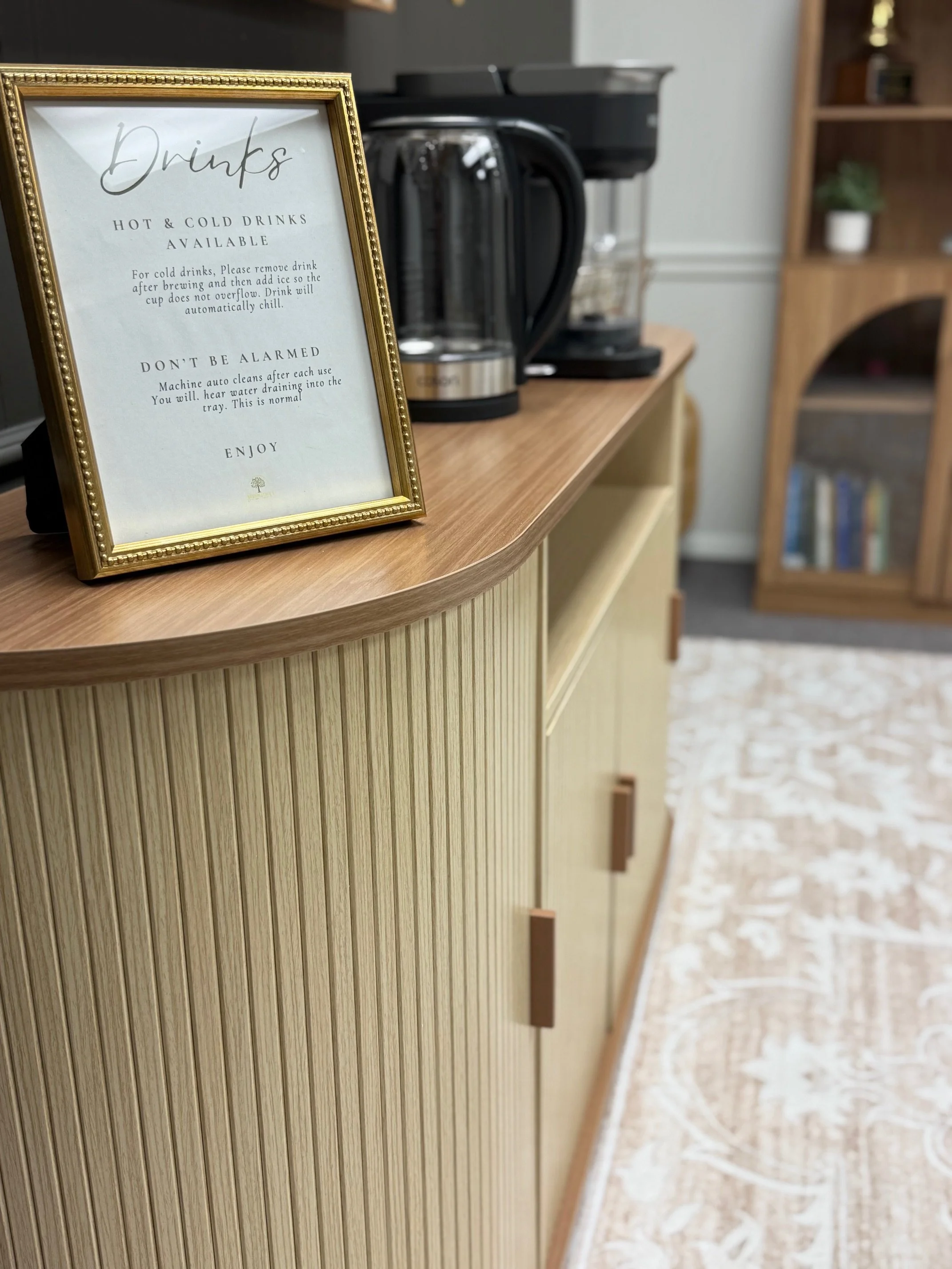 A close-up of a green plant with multiple oval-shaped leaves on a thin stem, against a plain white background.