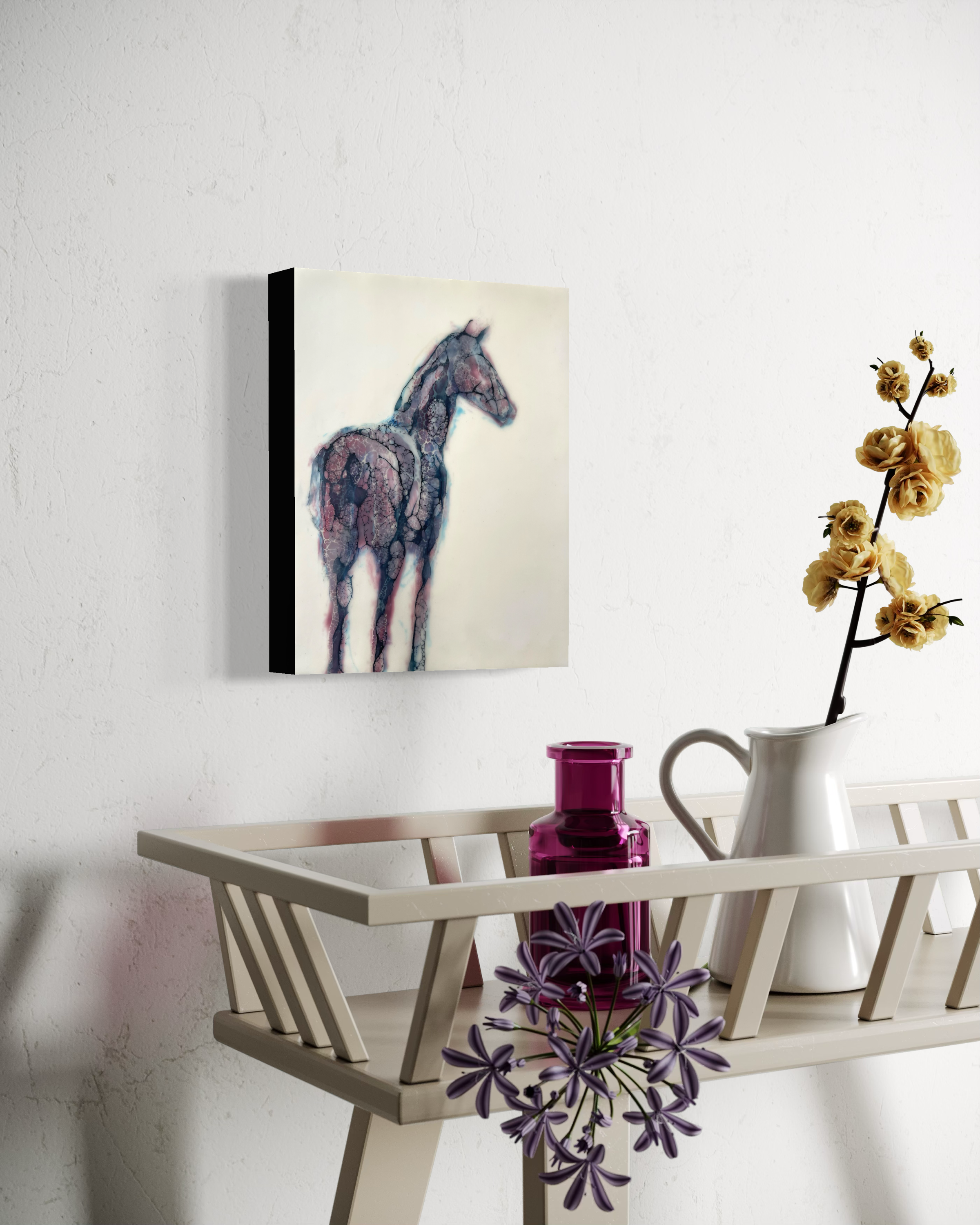 Minimalist interior mockup showing a small horse artwork on a white wall above a desk with books and a vase of yellow flowers.