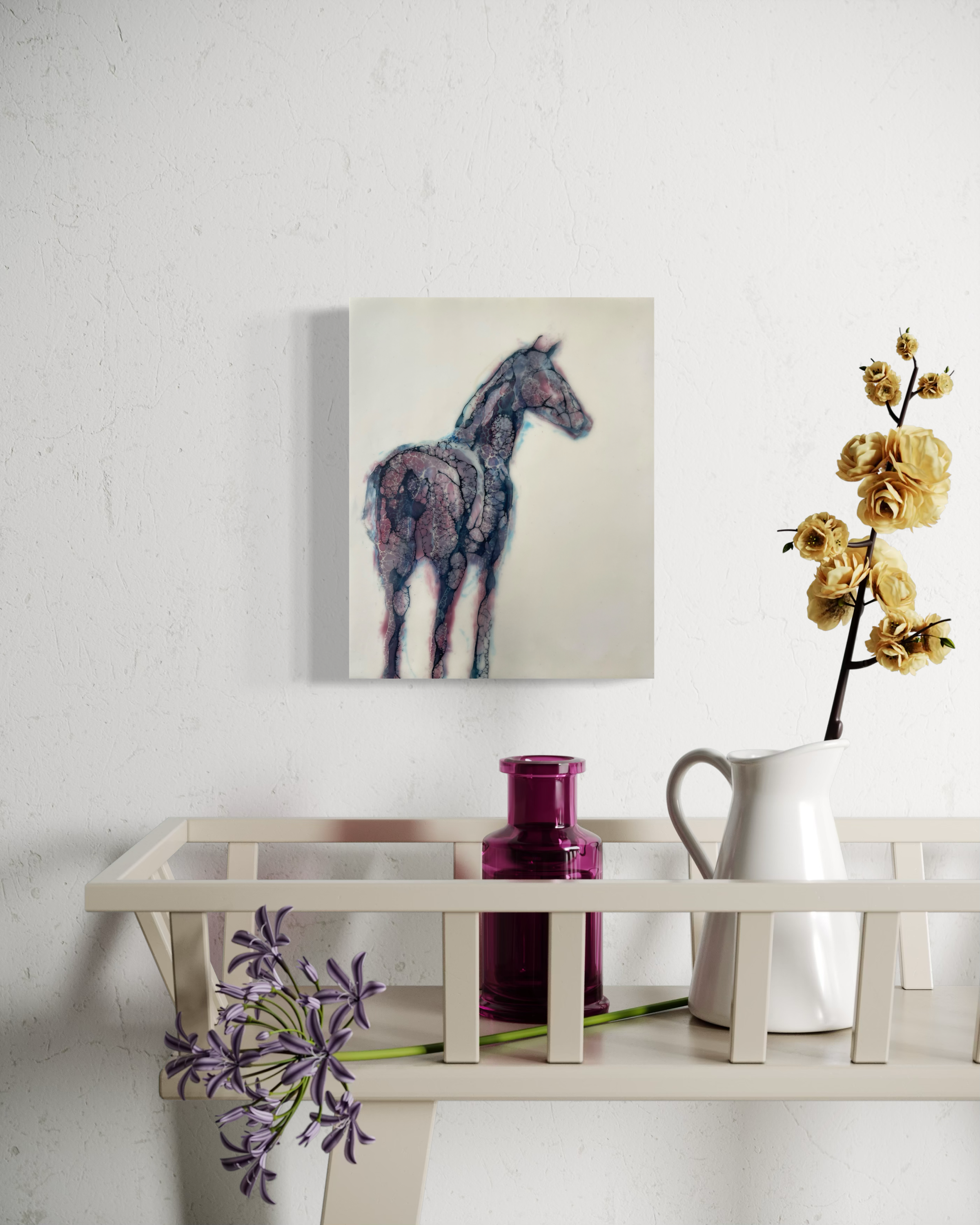 Small horse artwork displayed in a white wall above a desk with a plant stem, and a mug in a minimalist interior.