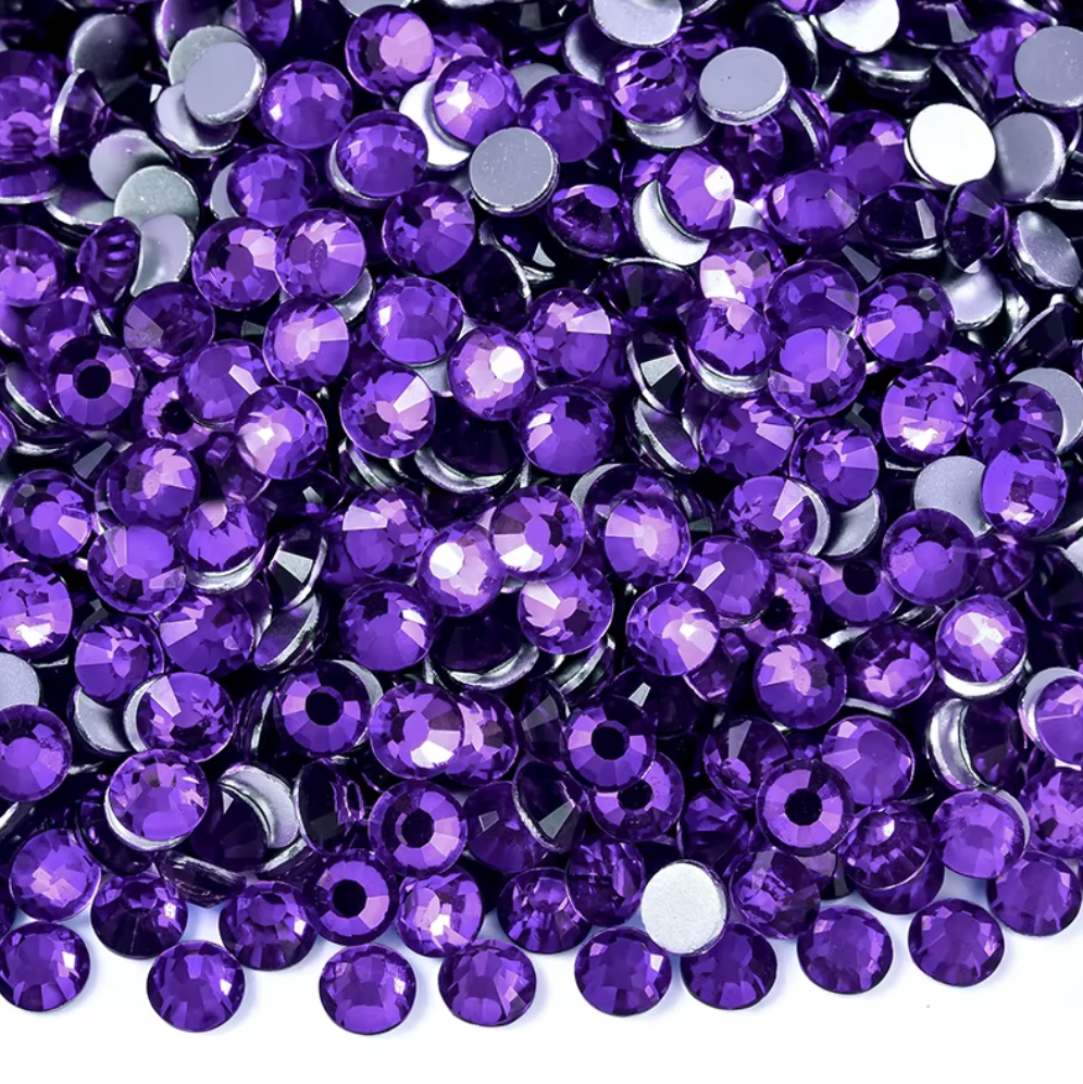 Heliotrope purple flatback rhinestones with high-shine faceted crystal finish in assorted sizes.