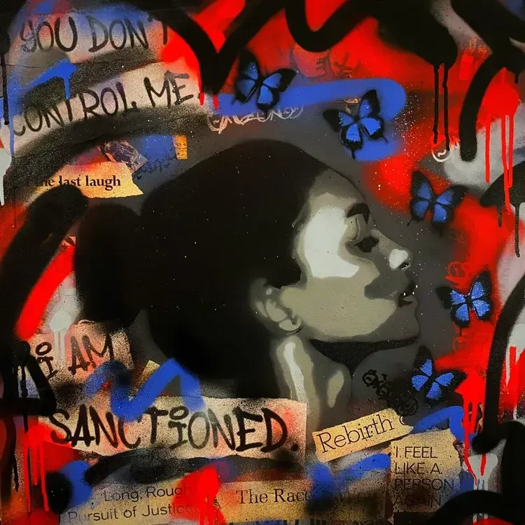 Street art mural featuring a woman’s profile surrounded by blue butterflies, with graffiti and pasted paper snippets including phrases like "You don't control me," "Sanctioned," and "Rebirth."
