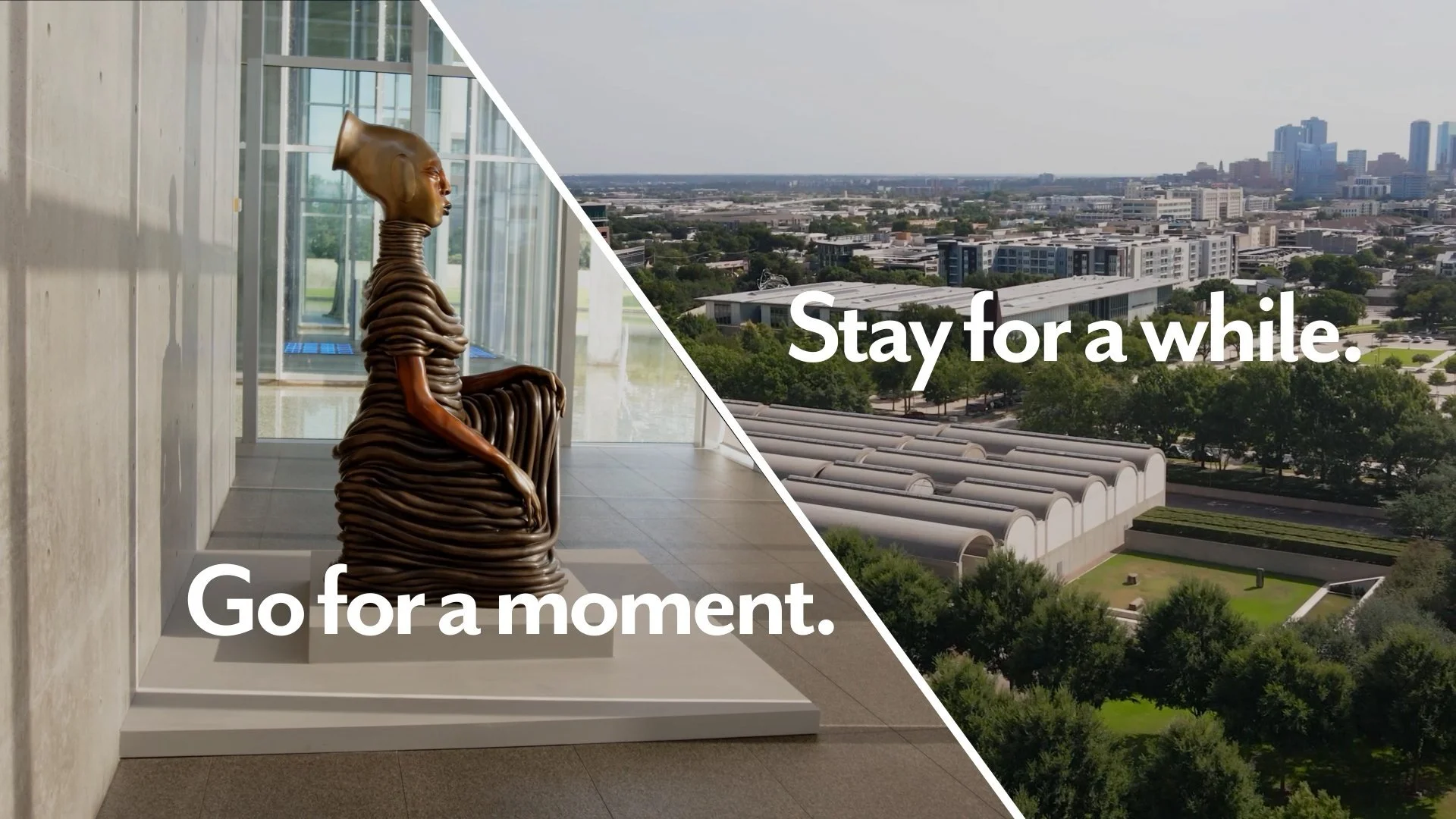An art installation of a humanoid sculpture with a head shaped like a cup, sitting on a chair made of coiled material inside a modern building with large glass windows. On the right side, a cityscape view with buildings, trees, and a clear sky. Overlay text reads: "Go for a moment. Stay for a while.".