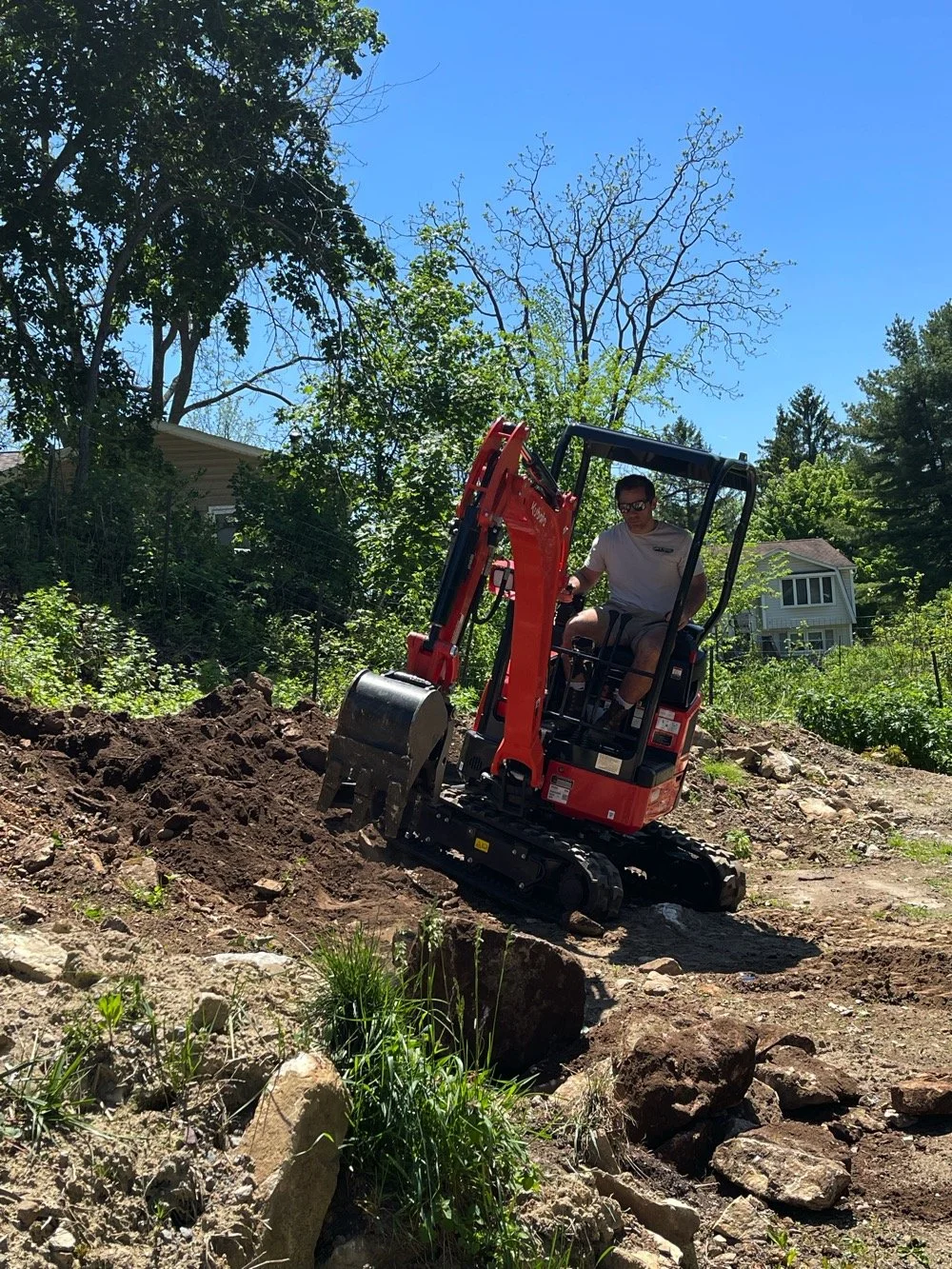Compact excavator in action.jpg