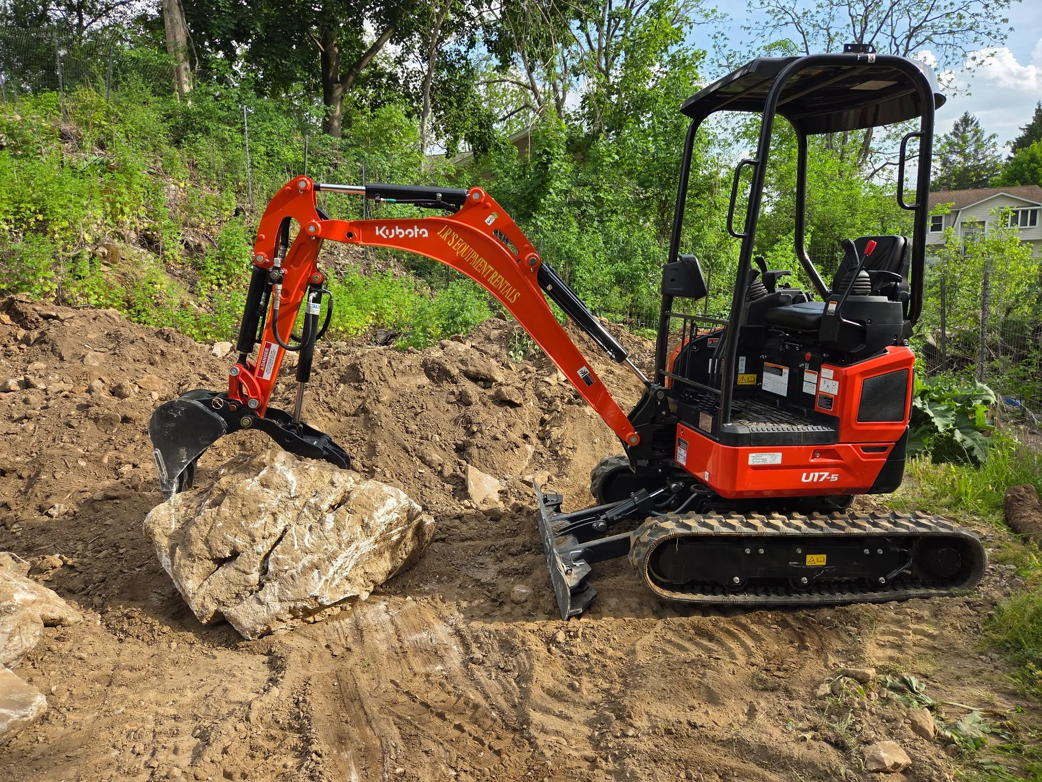 Compact excavator and a huge rock.JPG