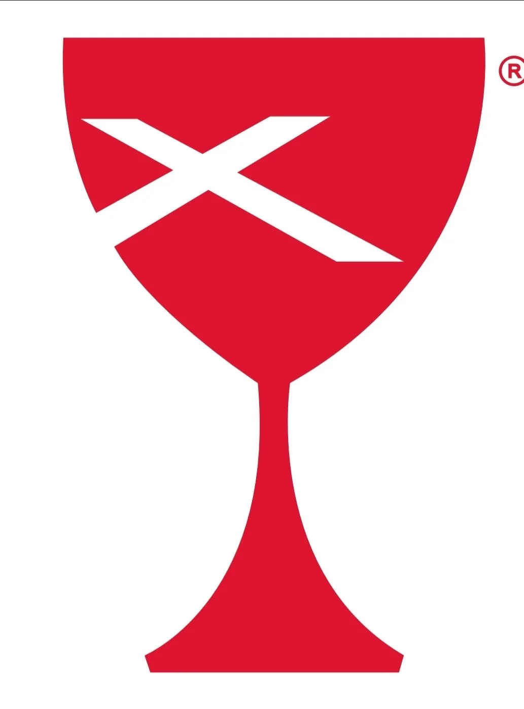A red cocktail glass with a white geometric cross design on the bowl.