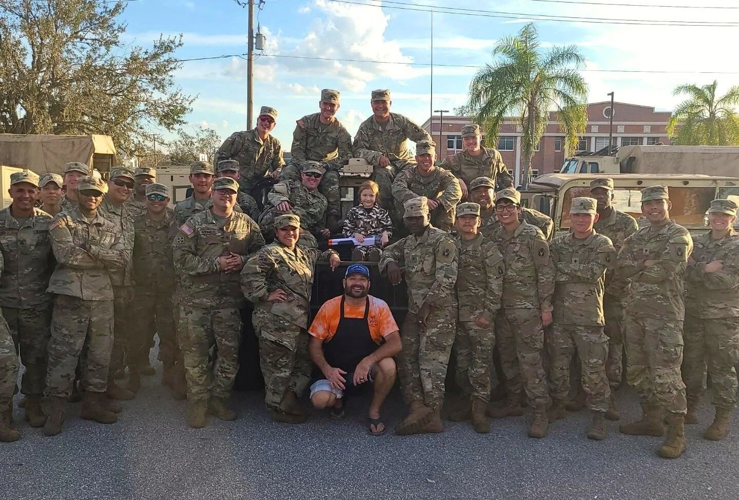 Smokin’ Crow’s BBQ team posing with National Guard members after providing meals during hurricane relief efforts in Southwest Florida.