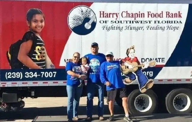 Smokin’ Crow’s BBQ team volunteering at a Harry Chapin Food Bank outreach event, supporting hunger relief efforts in Southwest Florida.