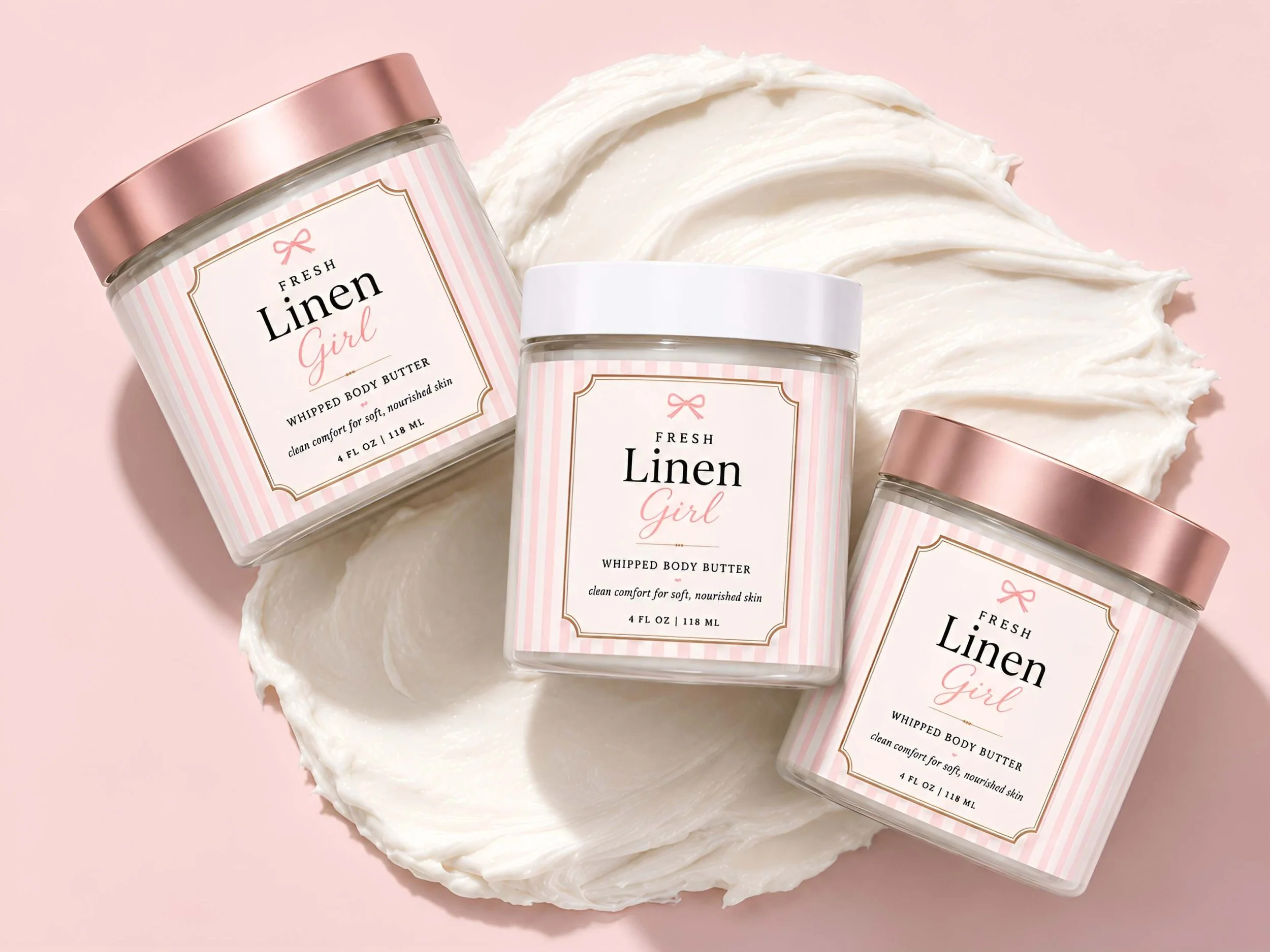 Fresh Linen Girl whipped body butter jar with a white lid on a marble spa counter with soft towels in the background.