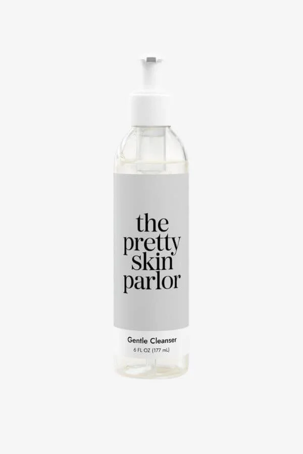 A clear plastic bottle of The Pretty Skin Parlor Gentle Cleanser with a pump dispenser, against a plain white background.