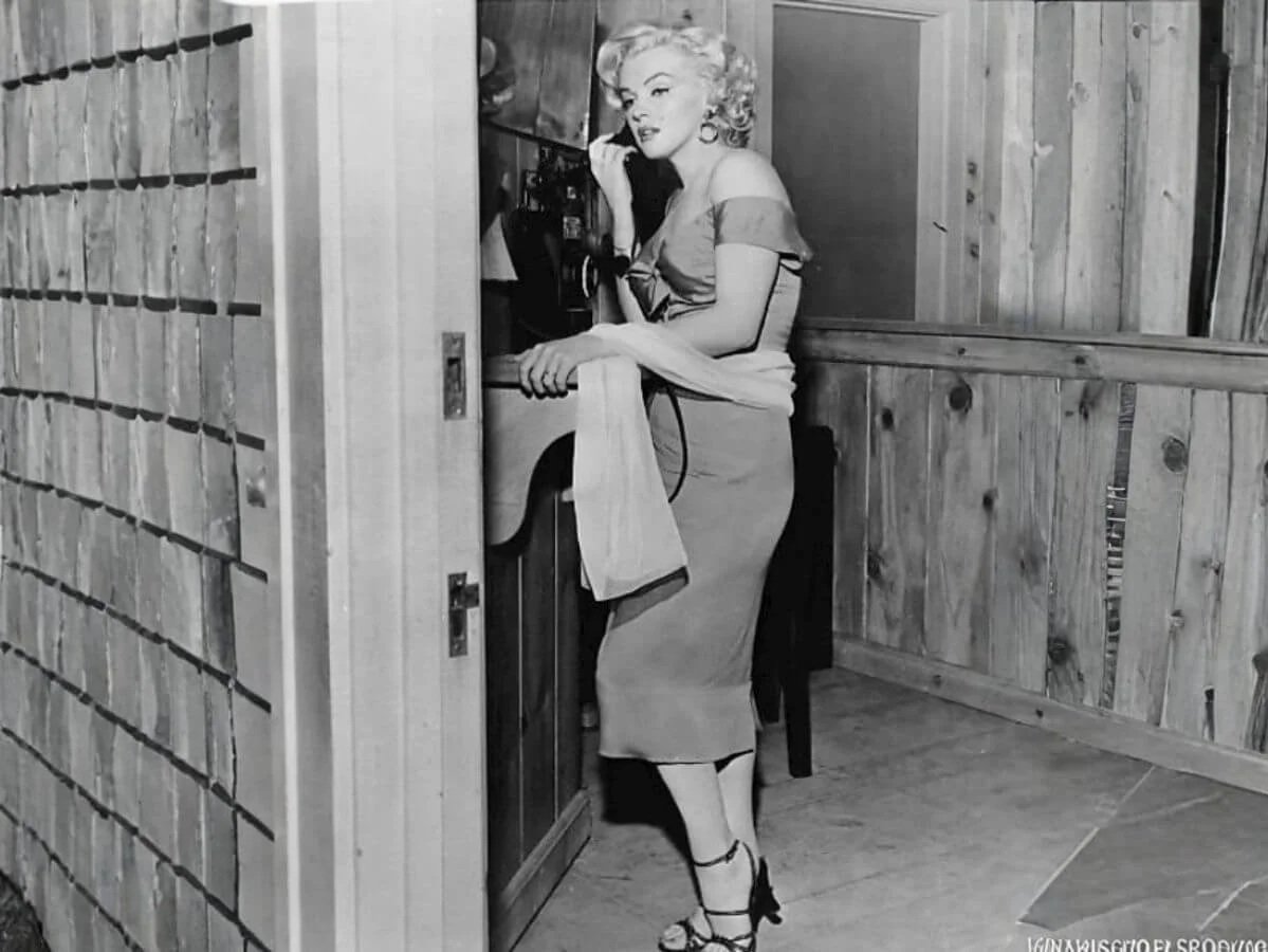 Marilyn Monroe standing in a doorway wearing a skirt and heels