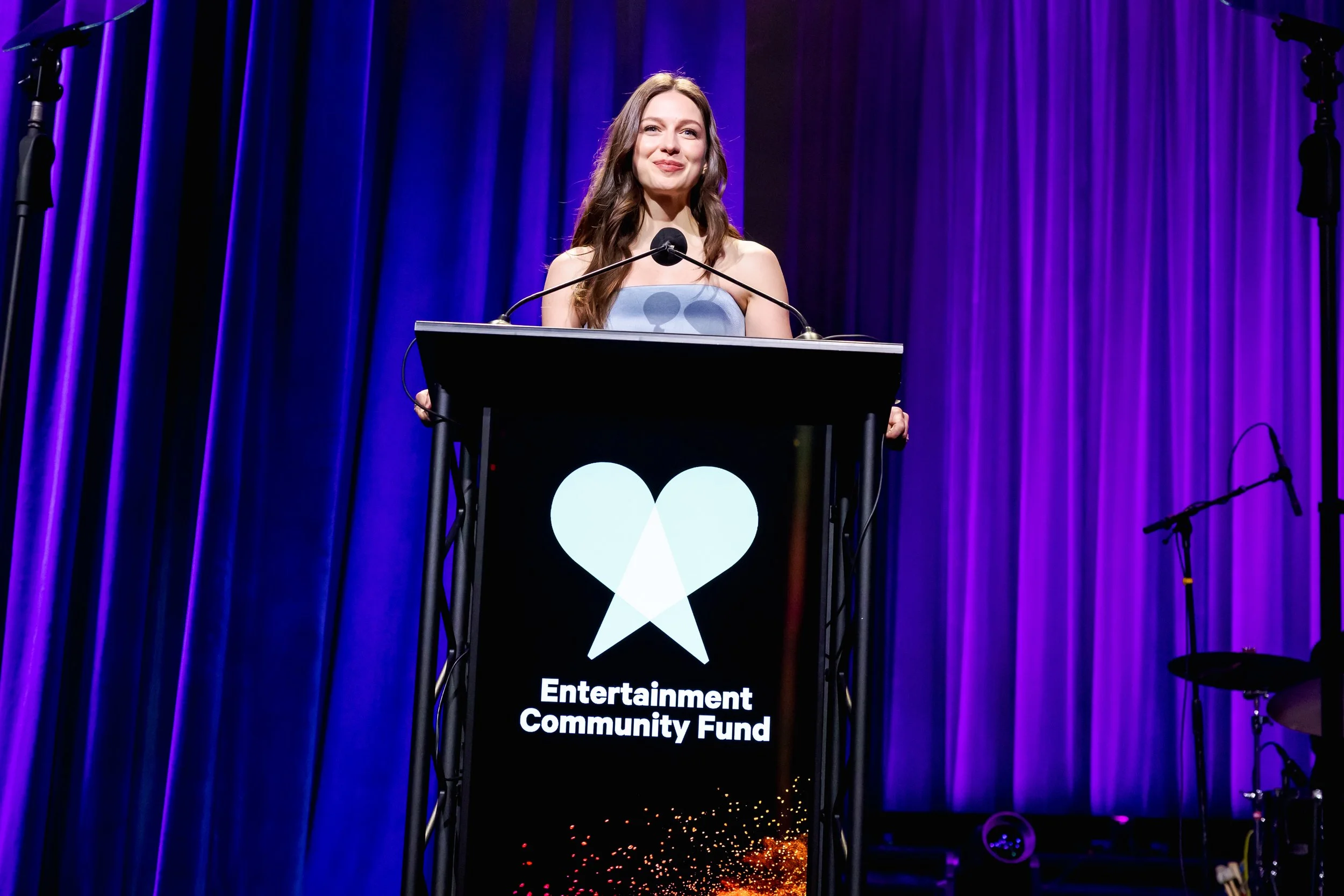Melissa Benoist speaking at a podium at Entertainment Community Fund gala
