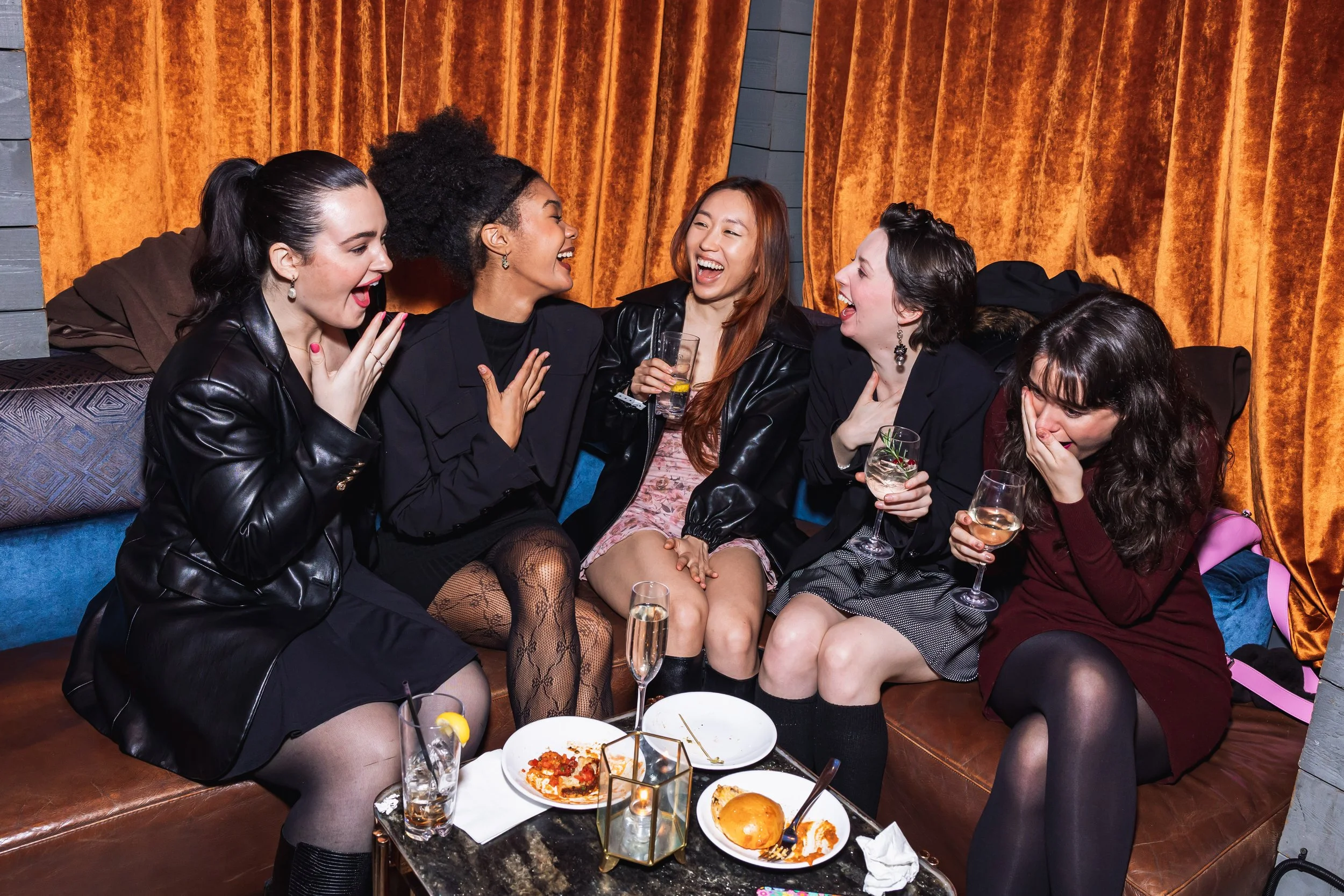 A group of young women laughing at a Maybe Happy Ending album listening party