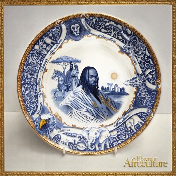 Decorative plate featuring a central portrait of a man with dreadlocks, surrounded by images of an aristocrat on horseback, a landscape with buildings and a sunset, and symbols of African culture, including an eagle and traditional patterns, with the