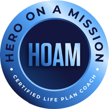 A circular badge with the text 'Hero on a Mission' around the top and 'Certified Life Plan Coach' around the bottom, with 'HOAM' in the center.