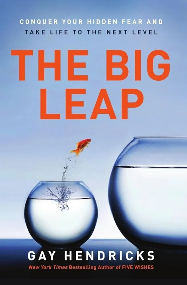 Book cover for 'The Big Leap' by Gay Hendricks, featuring an illustration of a goldfish jumping from a smaller fishbowl into a larger fishbowl against a blue sky background, with the title and author's name prominently displayed.