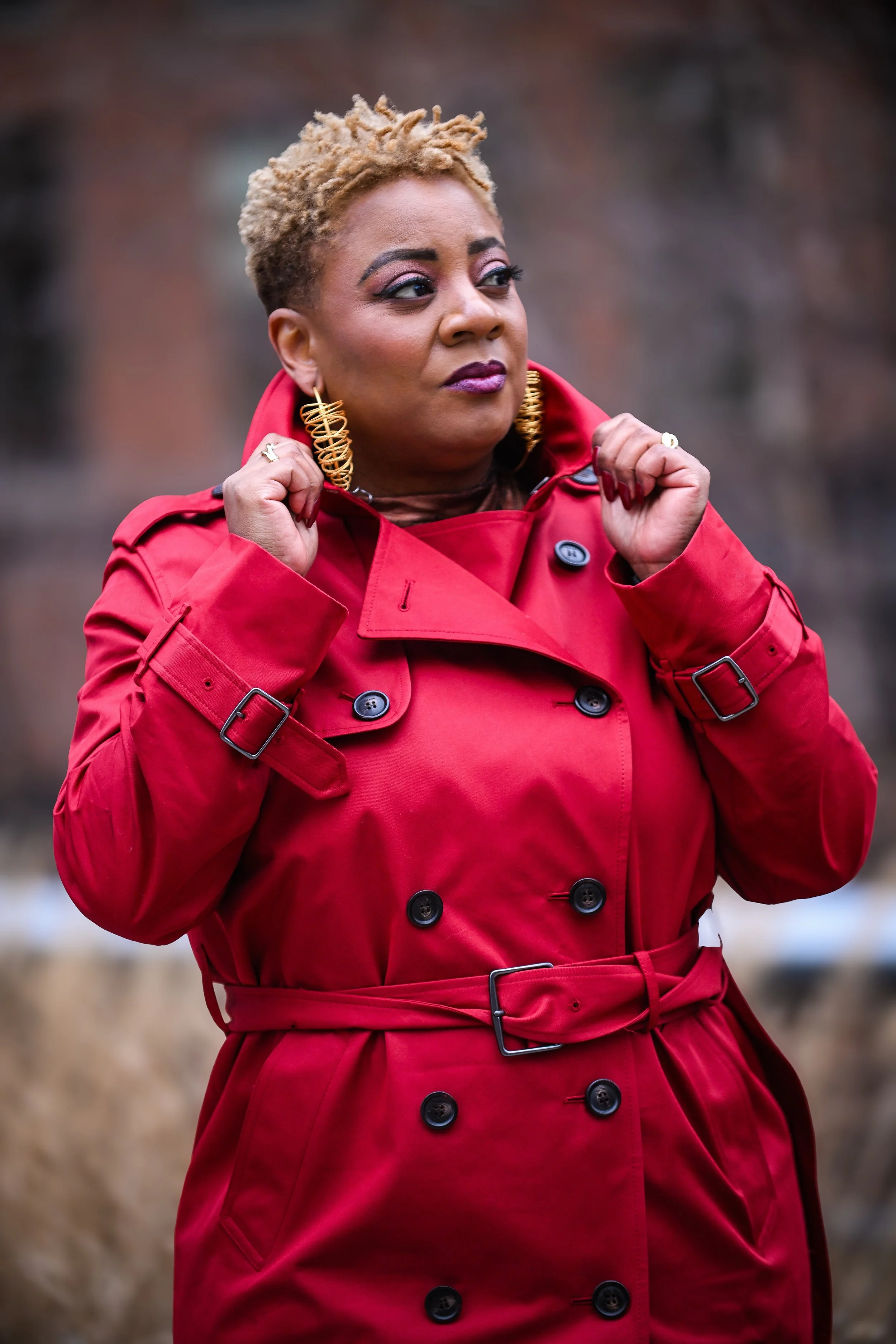 African american woman posing powerfully in a red trench