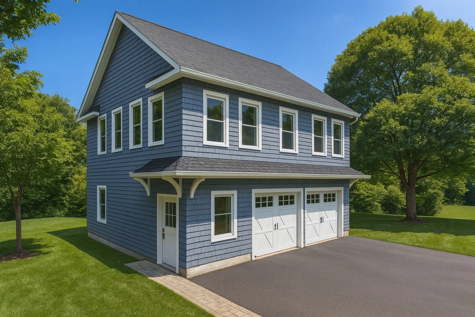 The Merrimack ADU model — 650 sq ft, one-bedroom home with a drive-under two-car garage, blue siding, white trim, and elevated front entry.
