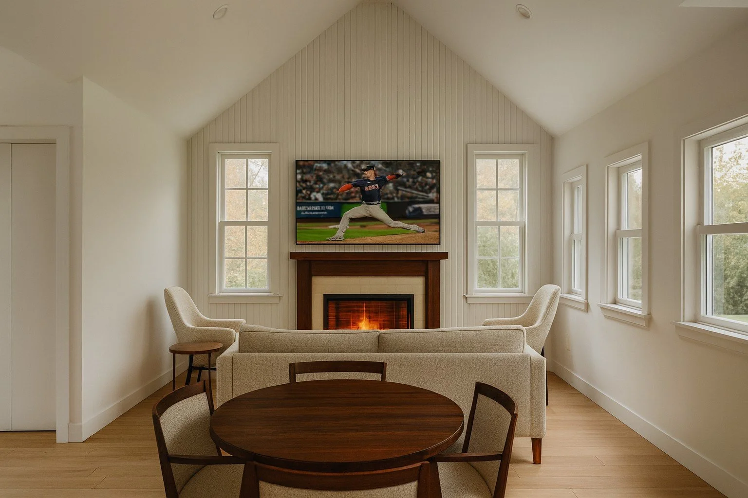 The Flume ADU model — 620 sq ft — interior rendering of living room and dining area with cathedral ceilings, fireplace media wall, and large windows.