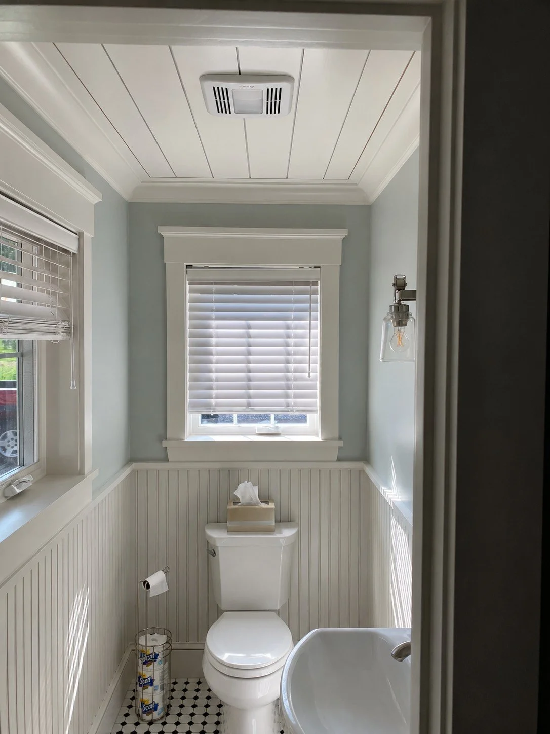 Powder room with beadboard walls, a window, and a paneled ceiling