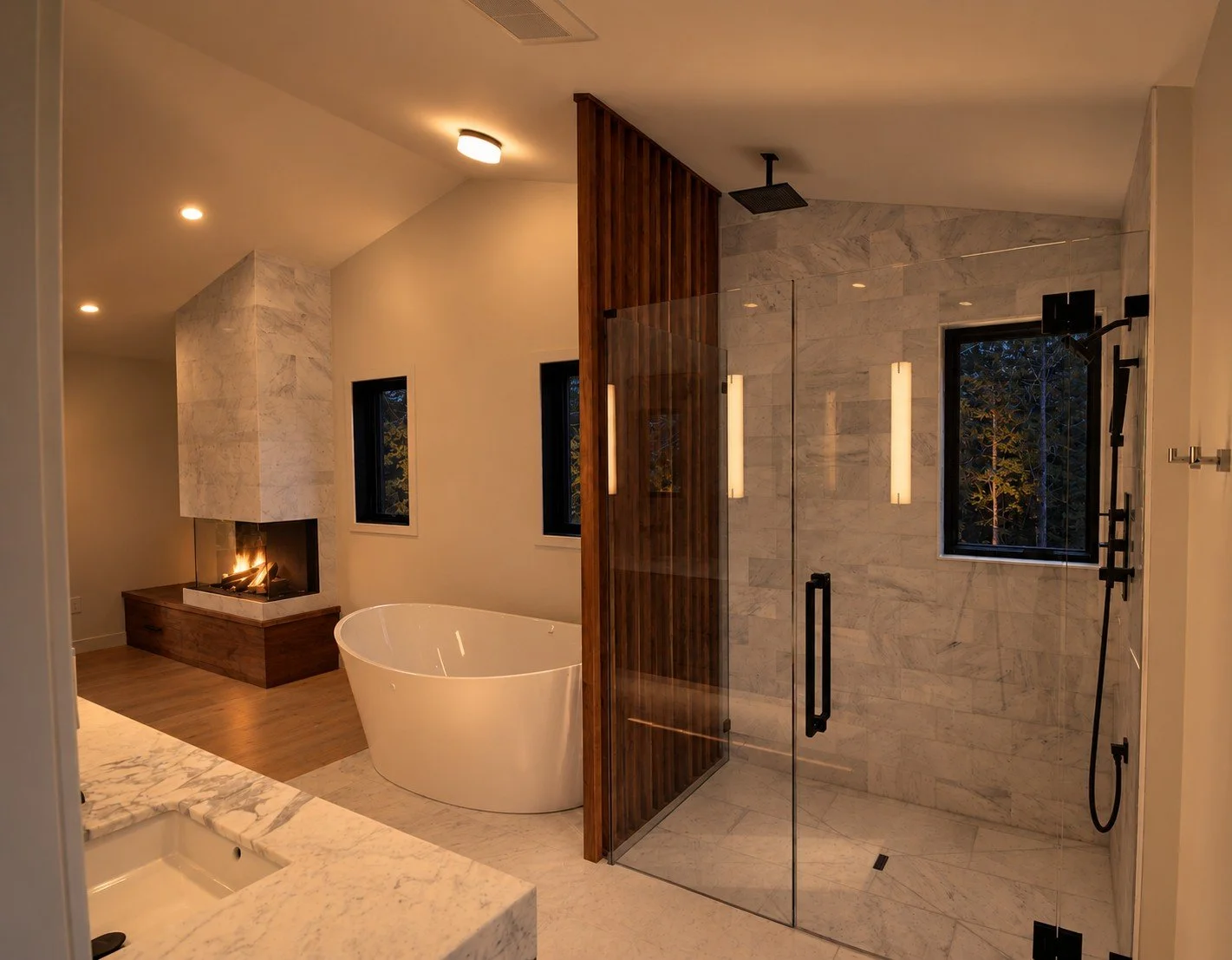 Primary bathroom with a freestanding tub, a glass shower, and a wood slat screen