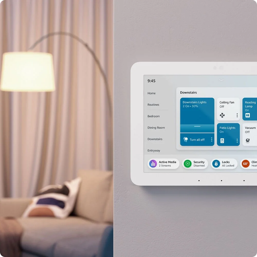 Smart home control panel on a wall next to a living room.