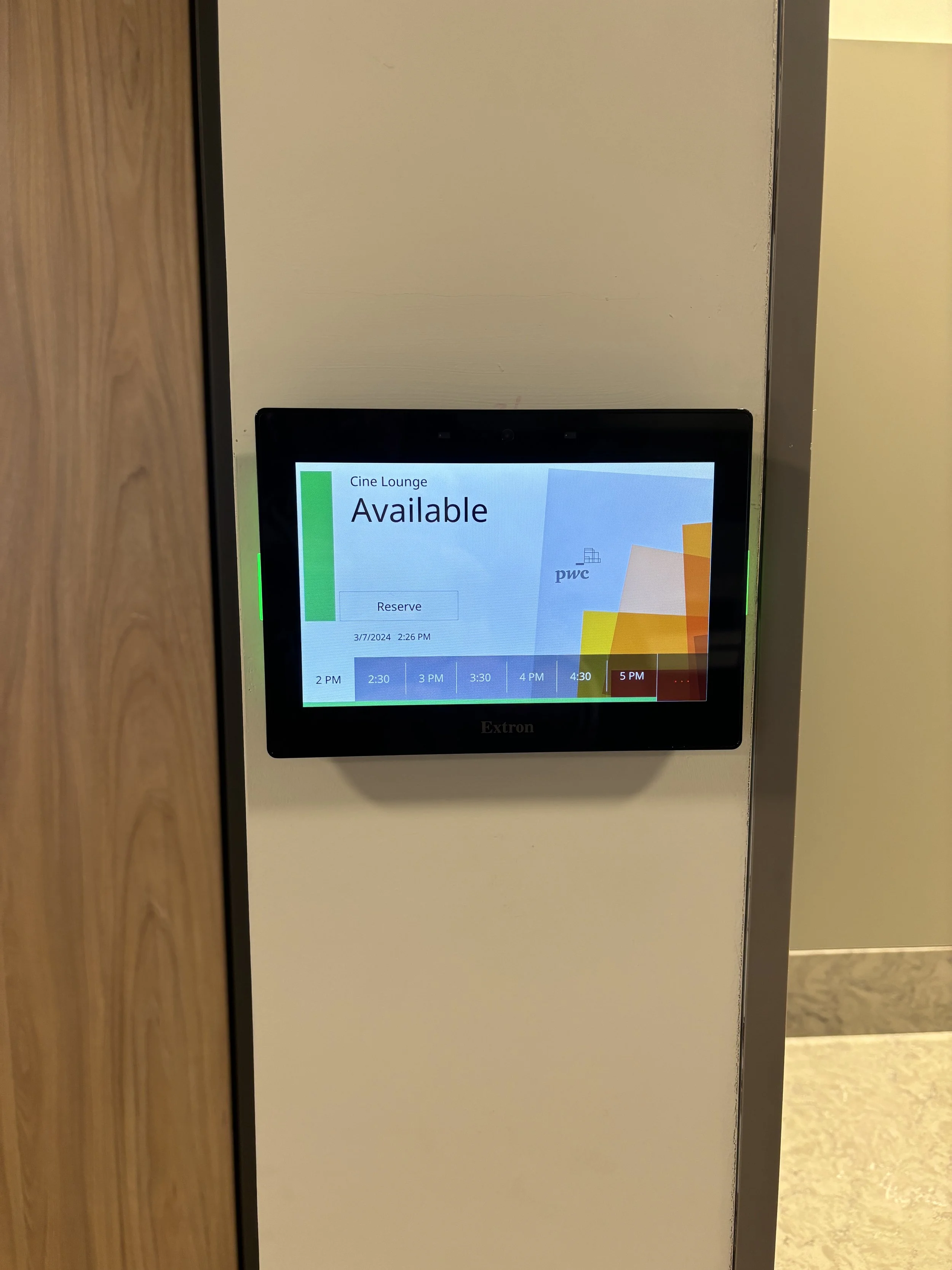 Digital screen in a movie theater lobby displaying the availability for 'Cine Lounge' reserved seating, with times from 2 PM to 5 PM on March 7, 2024.