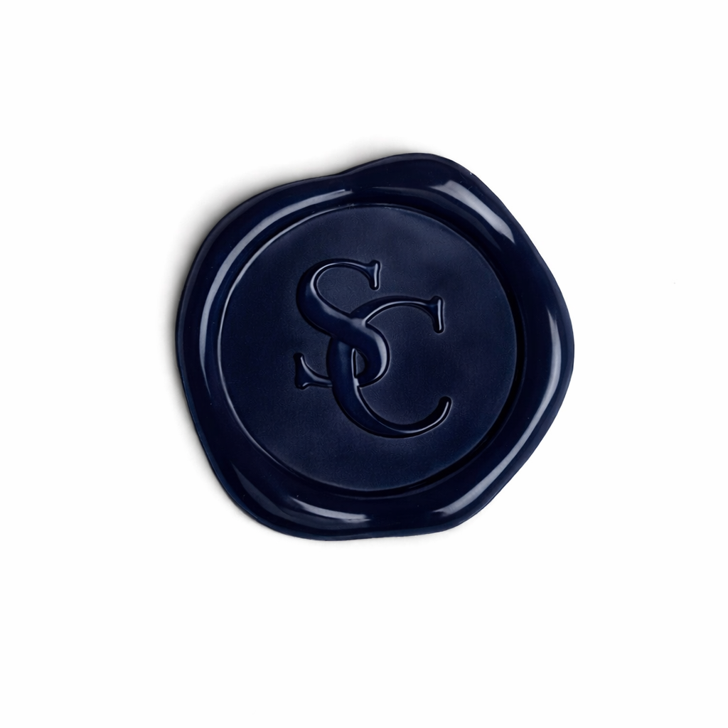 A navy blue wax seal with the intertwined initials SS and C on it, placed on a white background.