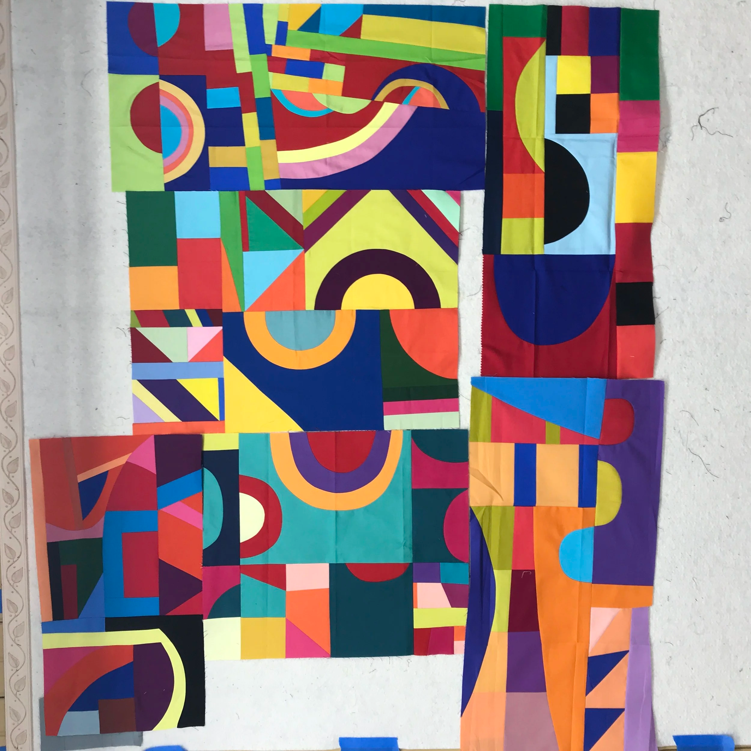 Individual blocks created by my Bee mates in response to the Sonia Delaunay prompt, shown before assembly