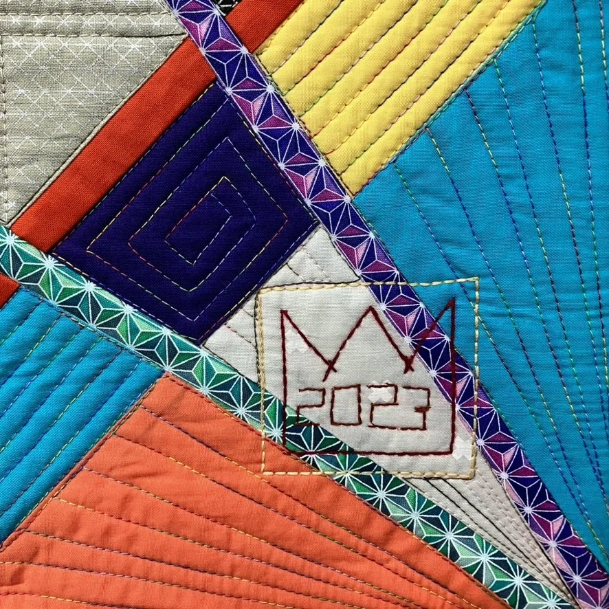 Close-up detail of the quilting in Descent into Chaos, including my signature mark.