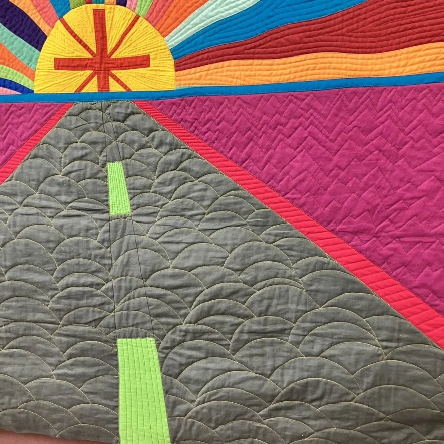 Detail view of the quilting, emphasizing stitched road lines and surface texture.