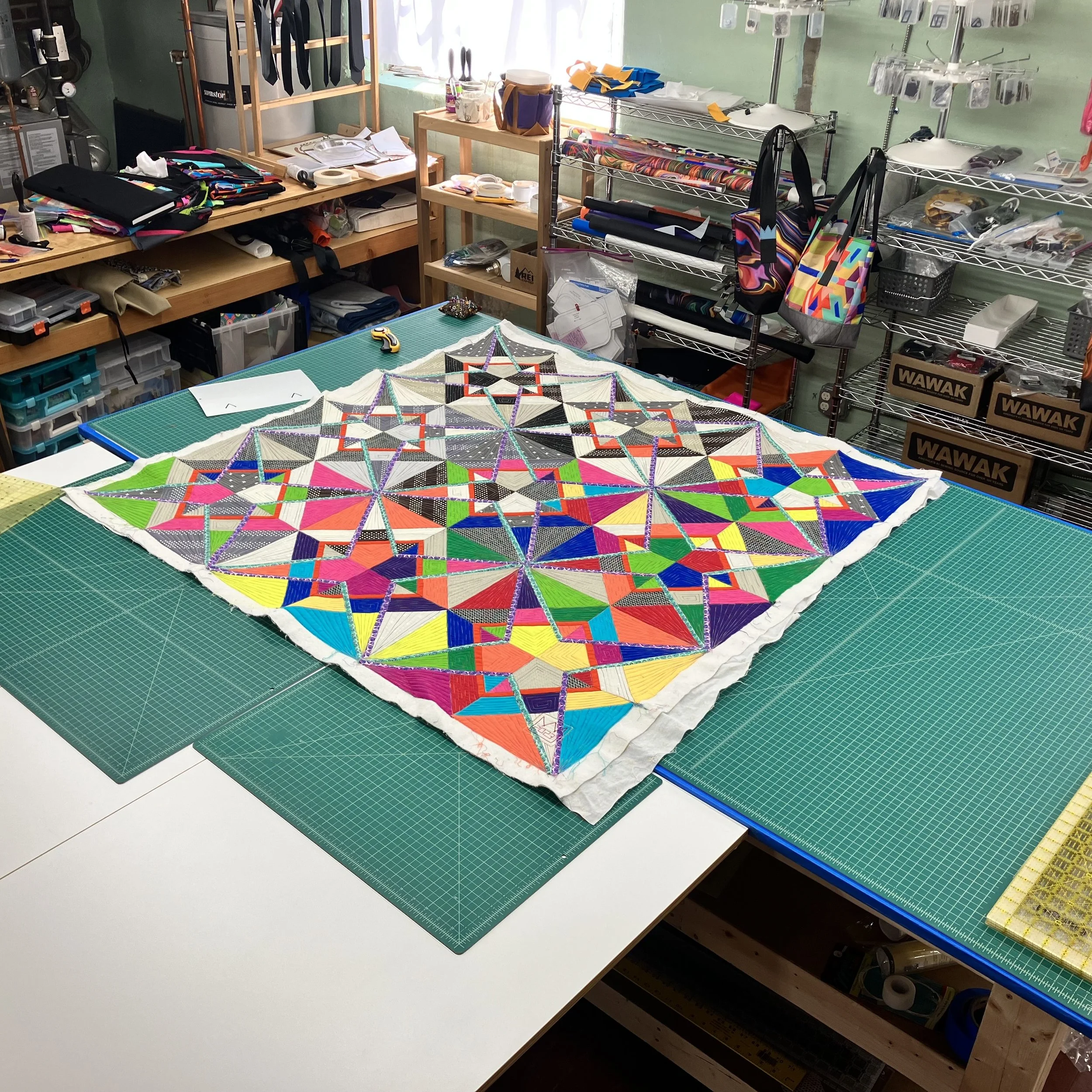 Quilt top fully quilted and ready to be trimmed prior to finishing Descent into Chaos.