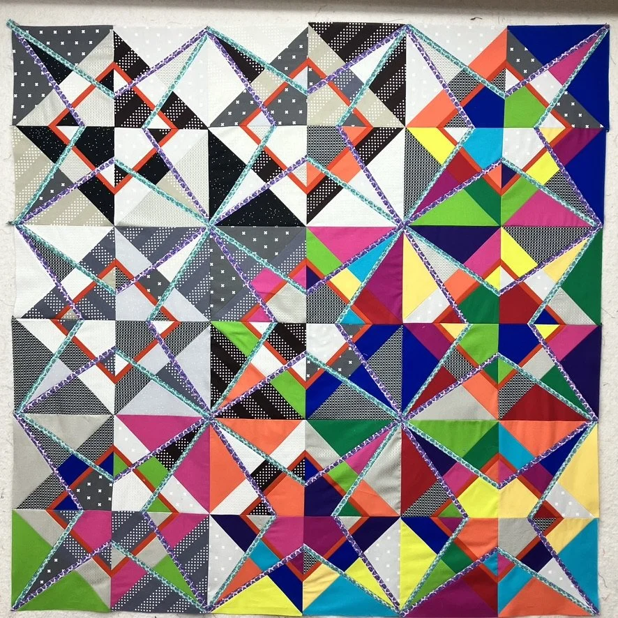 Completed quilt top sewn together and prepared for quilting in Descent into Chaos.