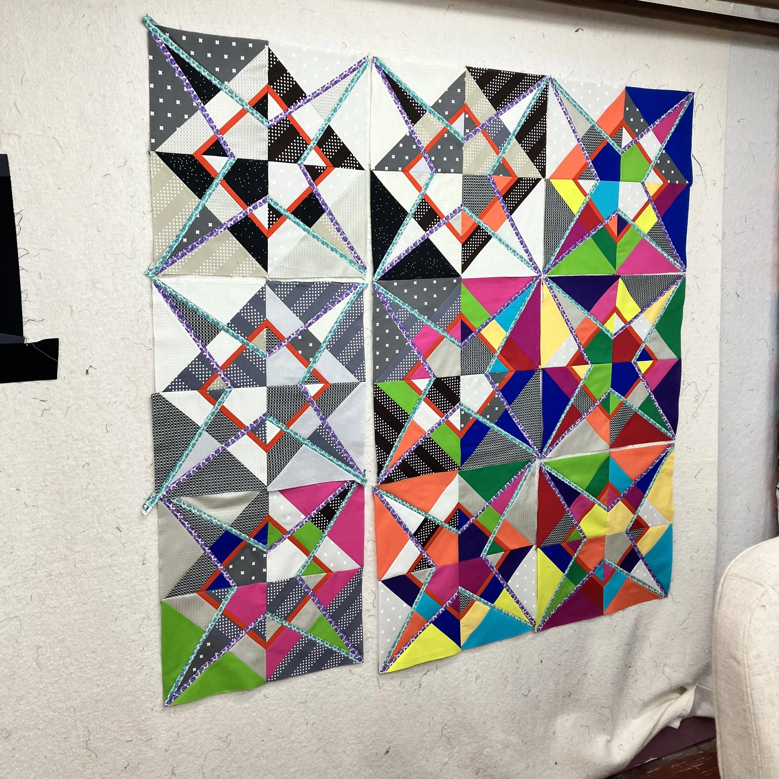 Blocks arranged prior to assembly of the quilt top for Descent into Chaos.