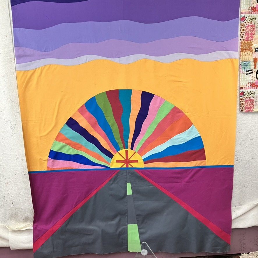 Finished quilt top prior to quilting, showing the completed composition and color relationships before stitching adds texture and depth.