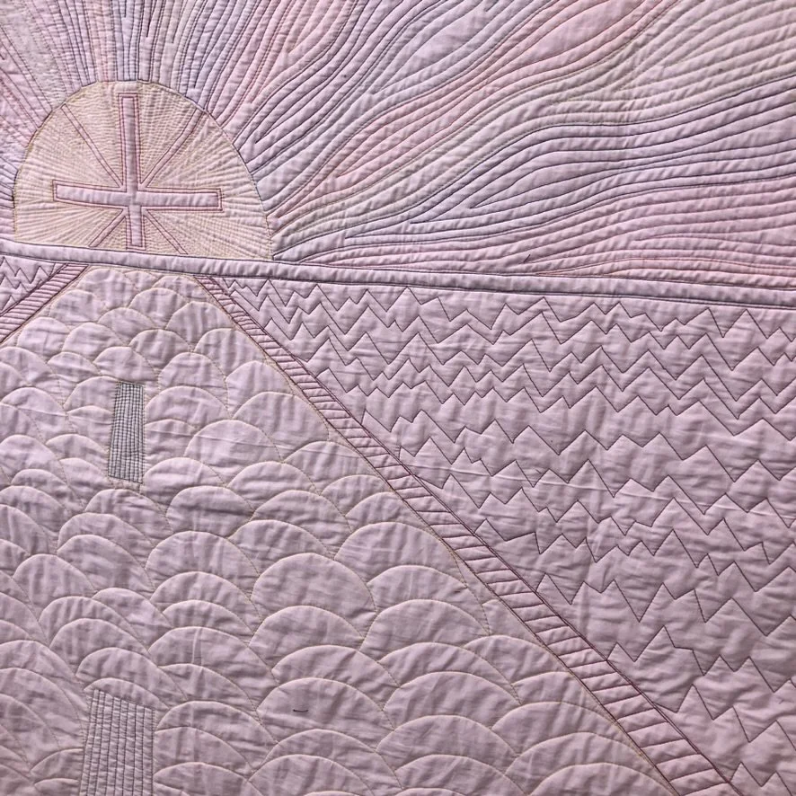 Detail view of the quilting on the back, showing the stitched road lines.